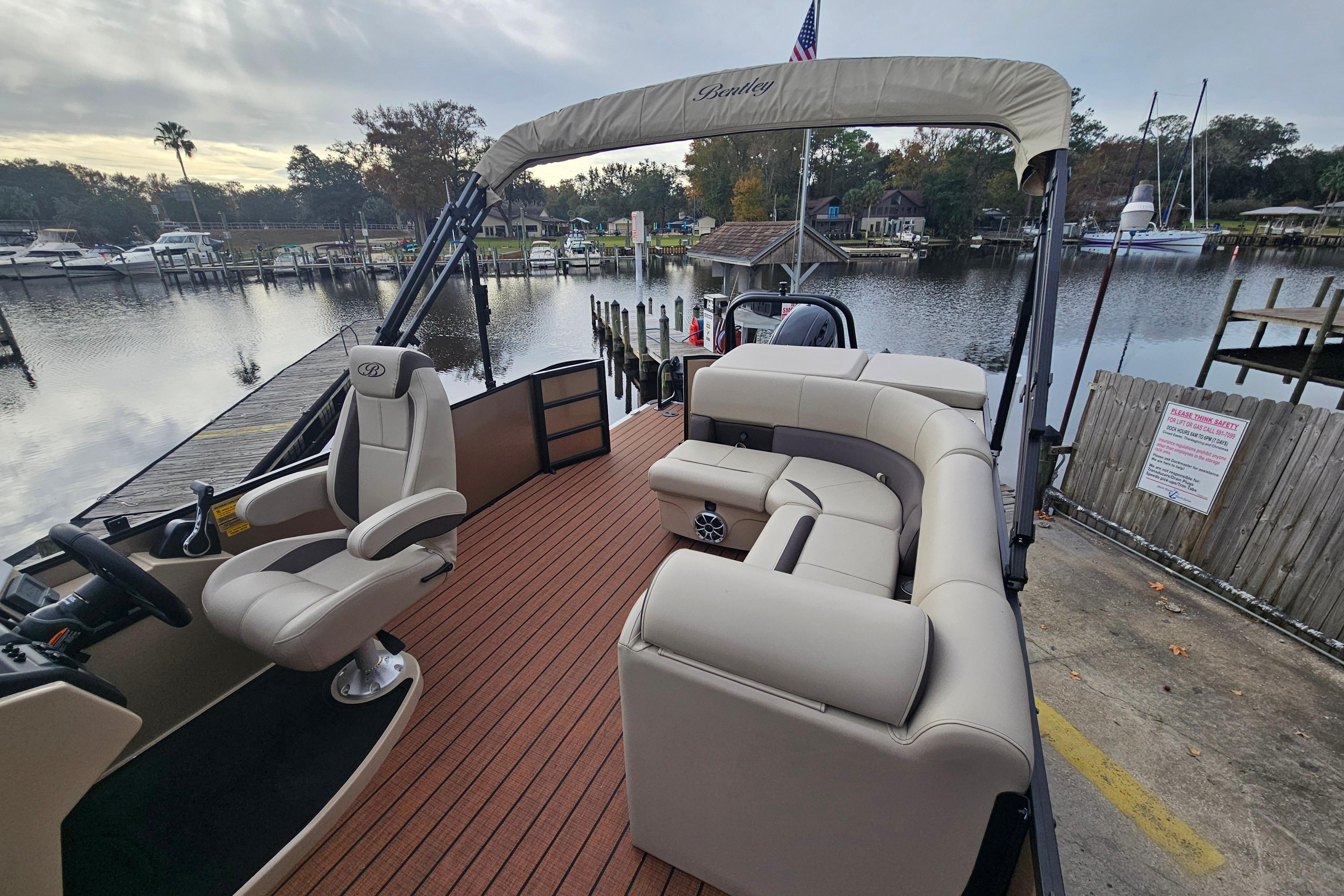 2026 Bentley Pontoons Legacy 243 Cruise at a scenic dockside location.