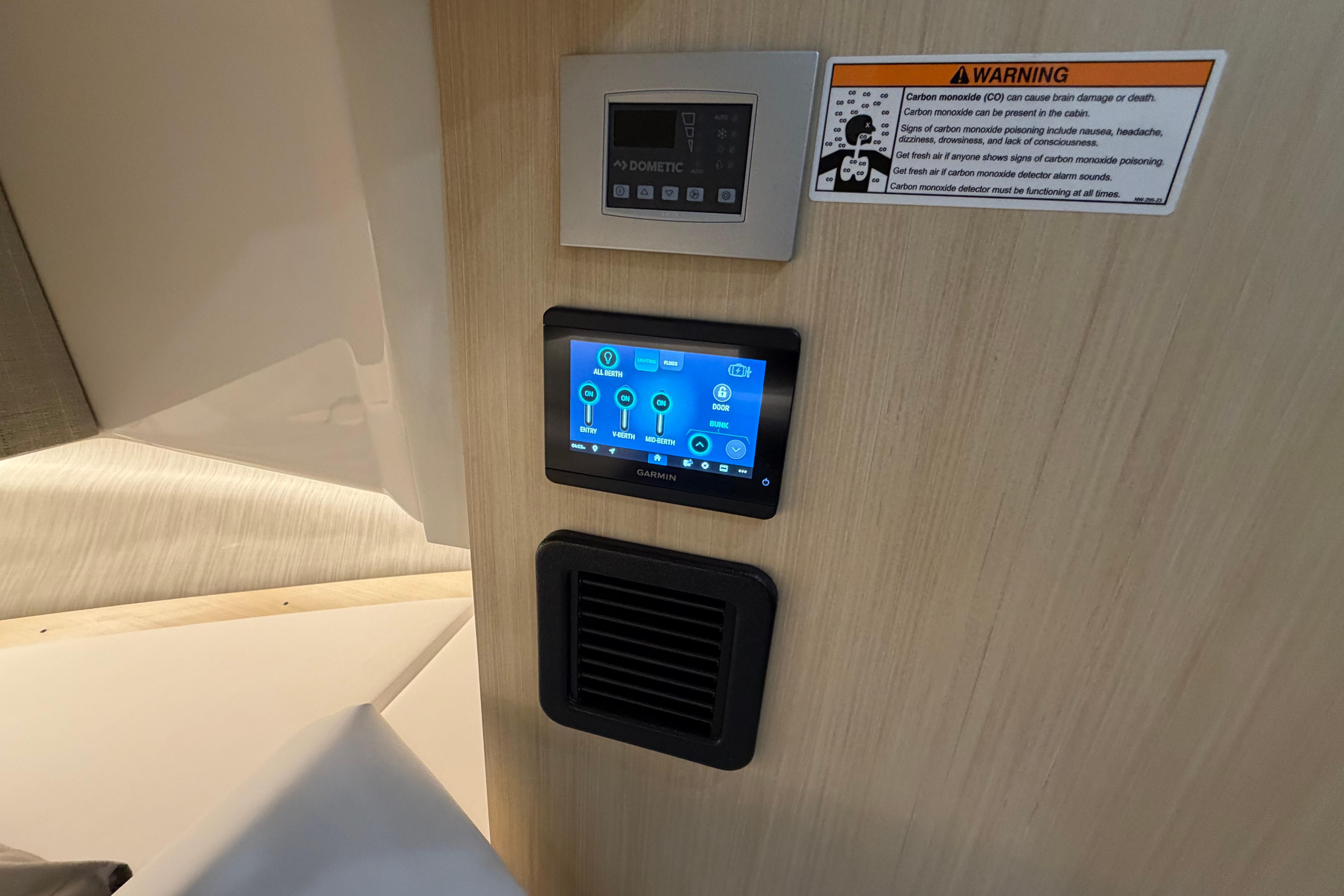 Control panel and warning label inside 2027 Regal 38 Surf boat cabin.