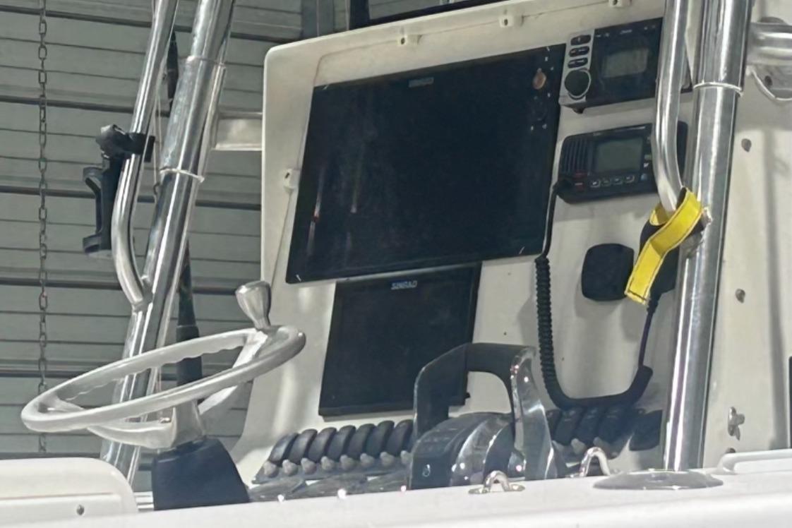 2005 Contender 35 ST boat dashboard with steering wheel and navigation equipment.
