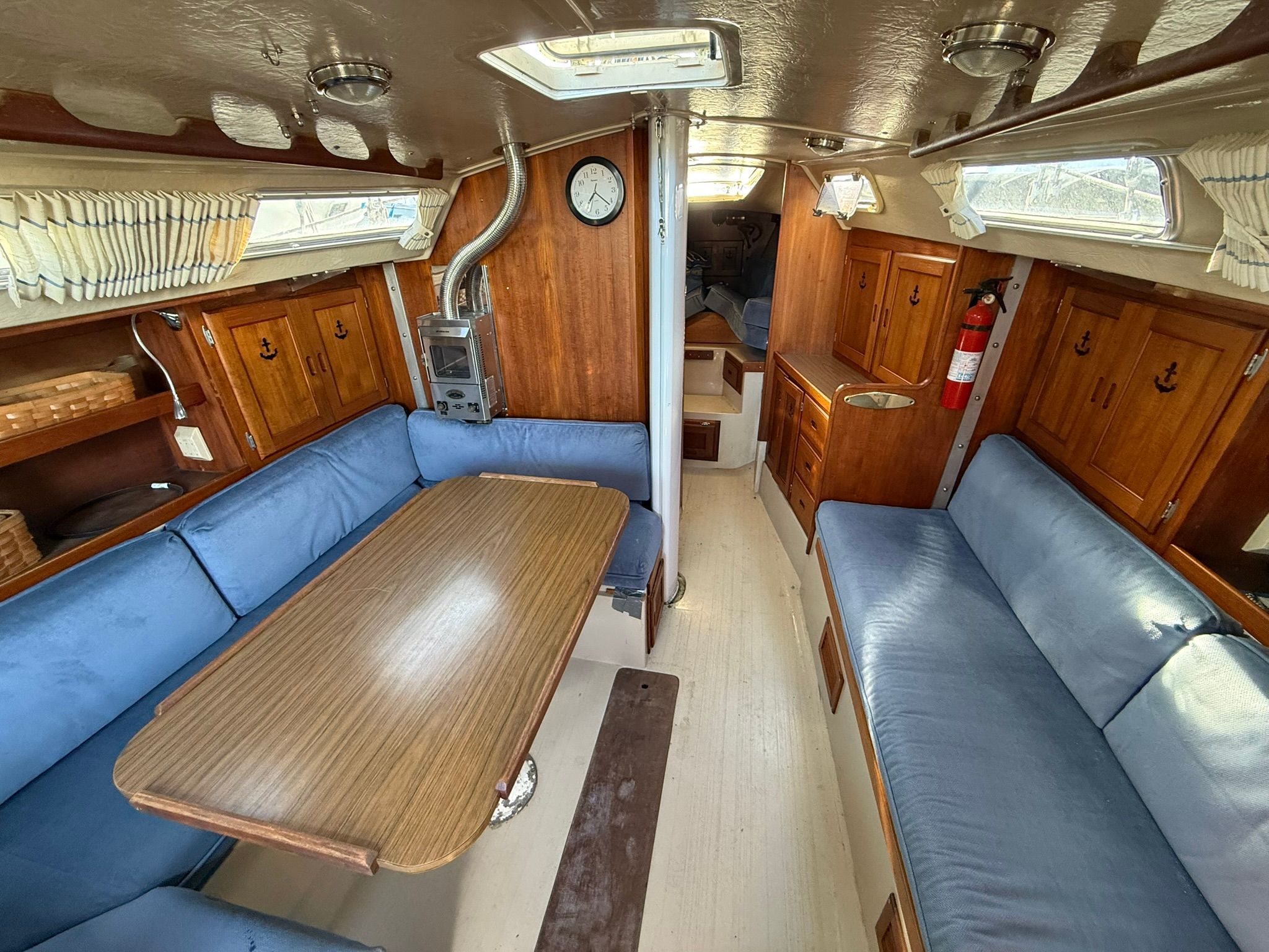 Interior of a 1980 Catalina 38 yacht with blue upholstery.