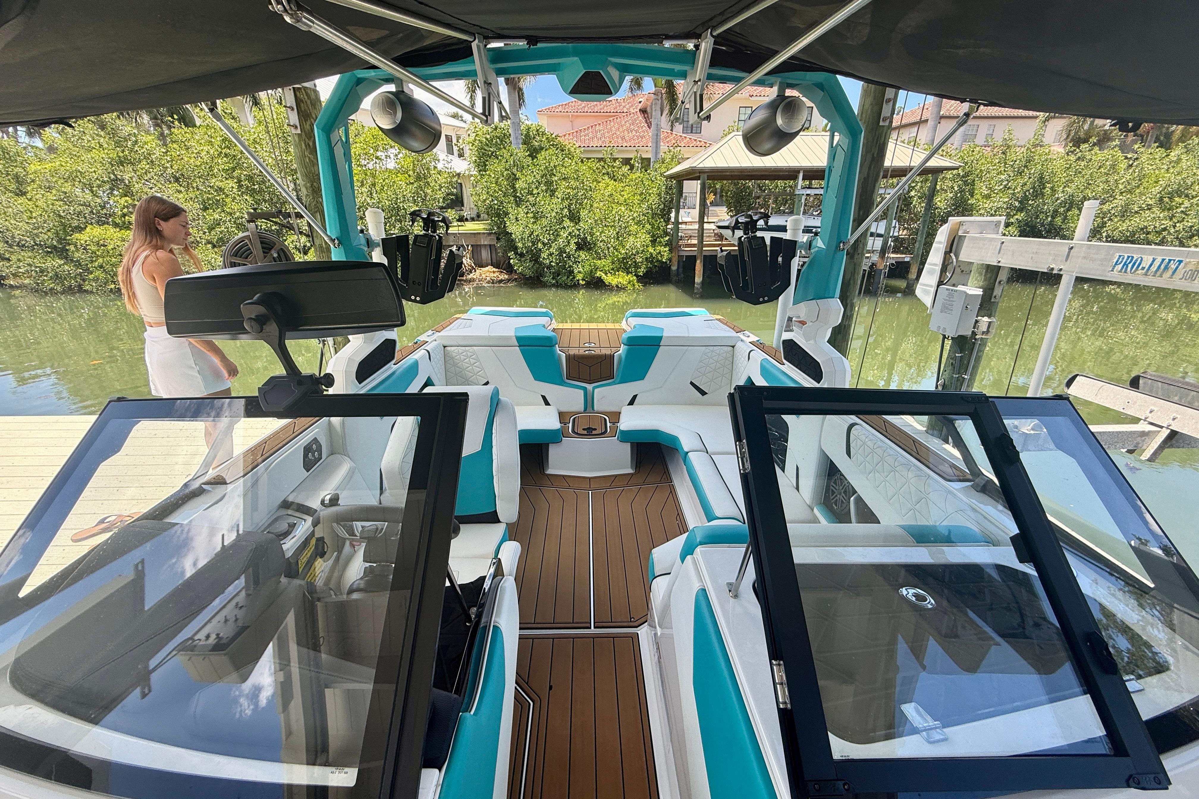 2024 Nautique Super Air Nautique GS20 boat interior with teal and white seating.