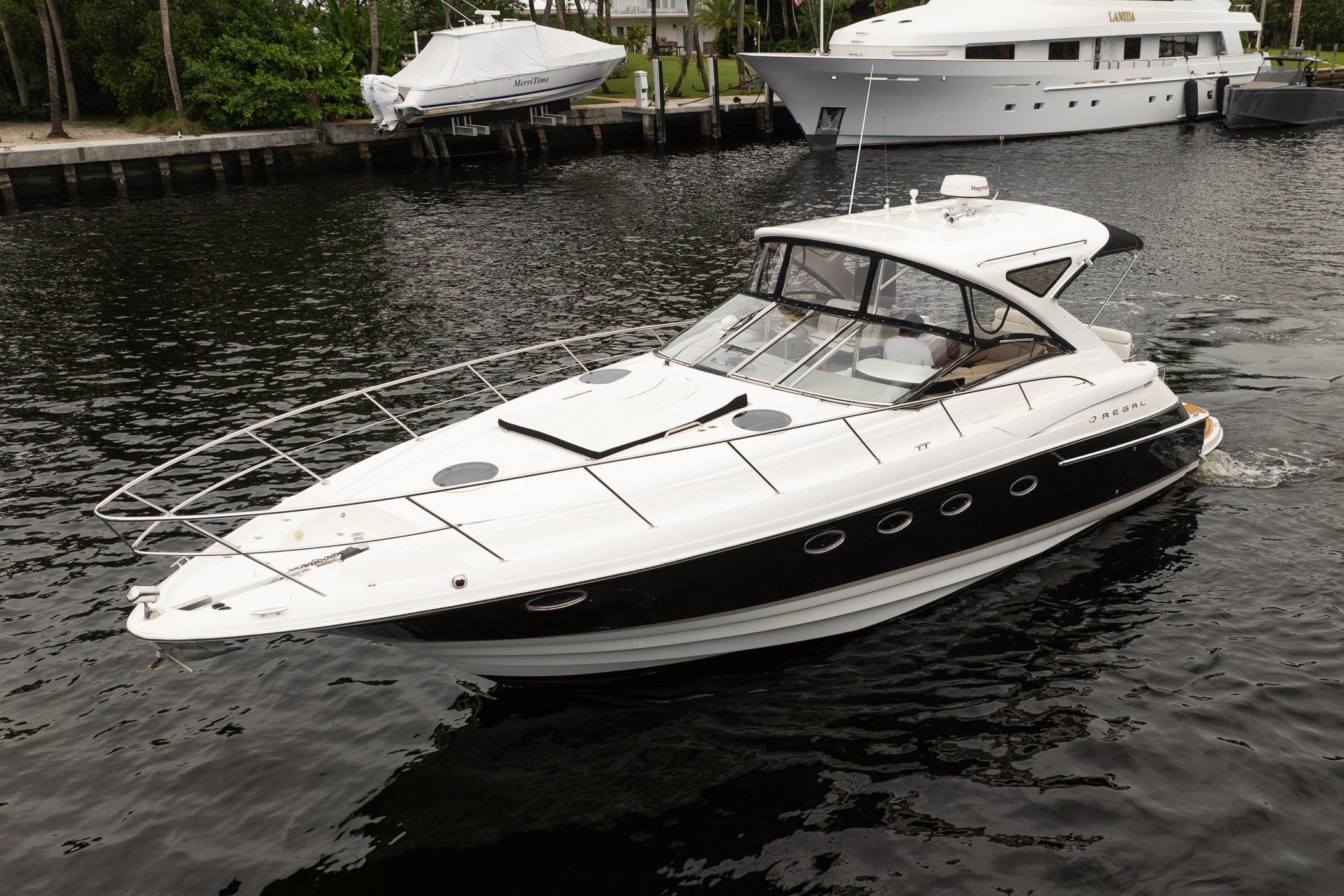 2008 Regal Commodore 4460 yacht cruising on a calm waterway.