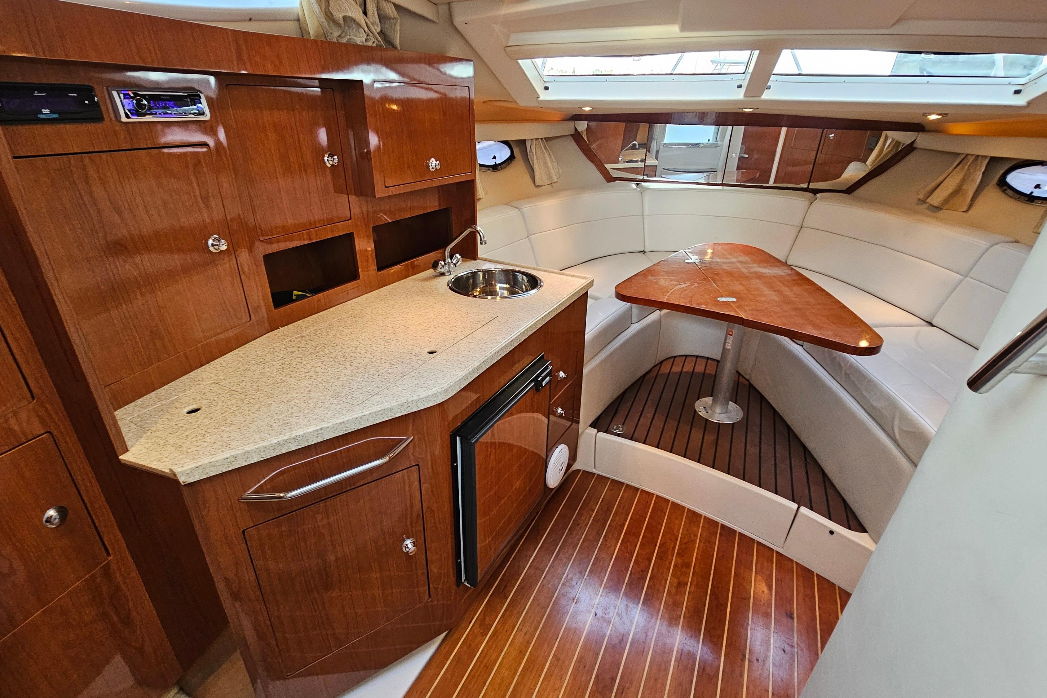 2005 Regal 3060 Window Express interior with kitchenette and seating area.