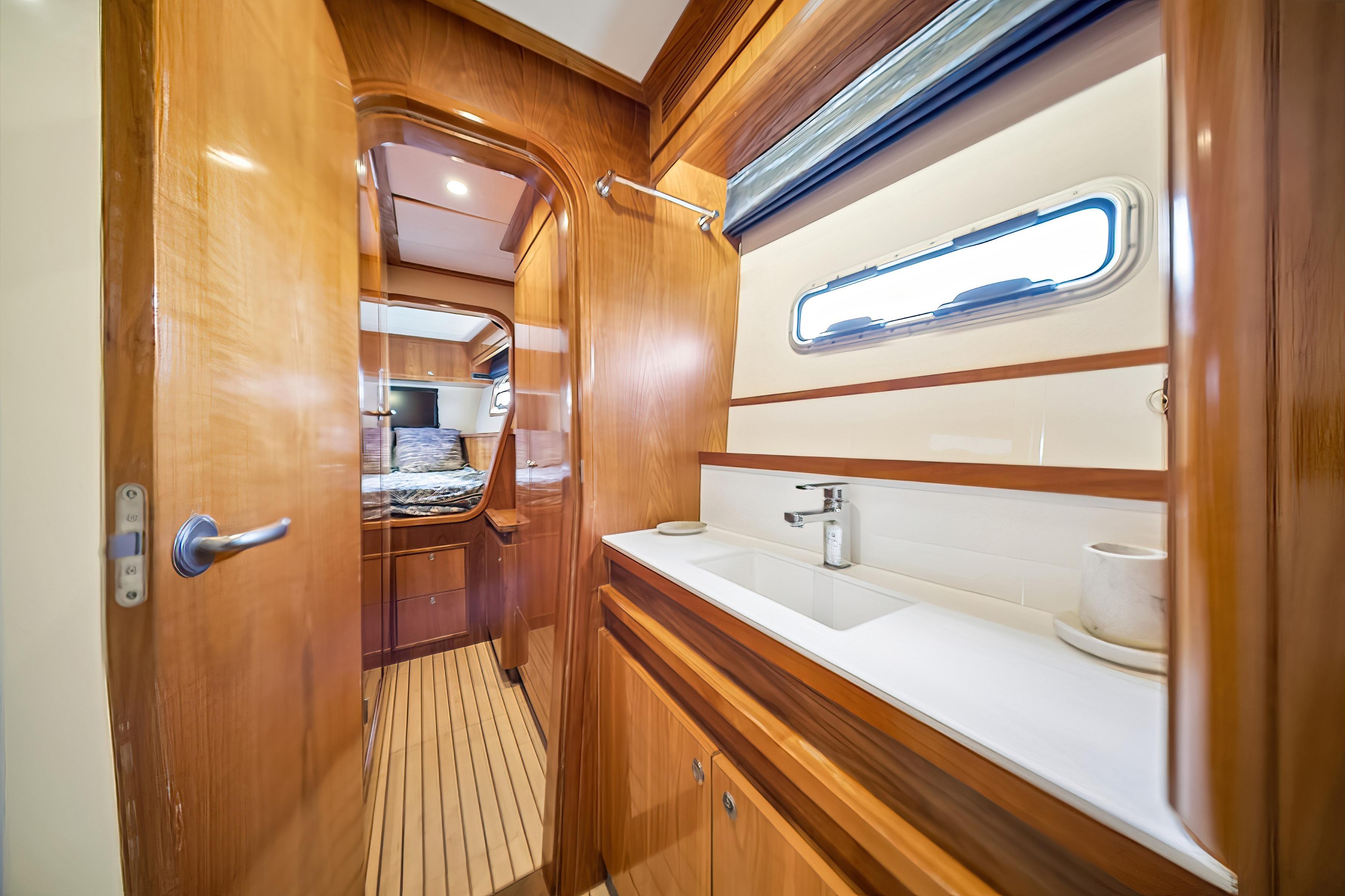 Luxurious Catana 65 yacht interior, featuring a sleek bathroom and cozy bedroom, 2009 model.