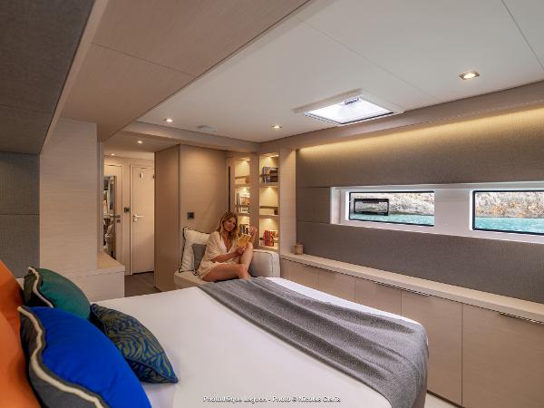 Luxurious interior of 2025 Lagoon 55 yacht with cozy bedroom and modern design.