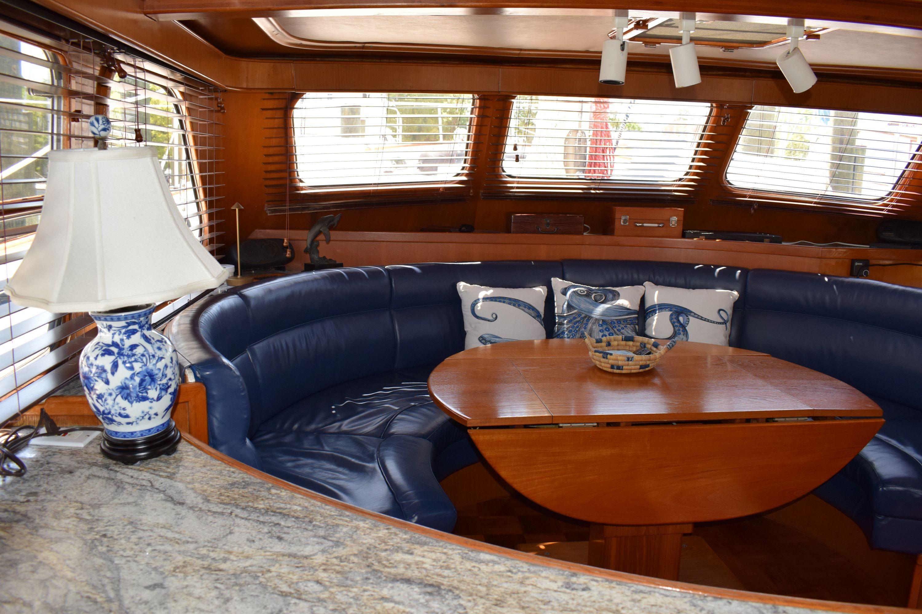 Luxurious interior of 1980 Cheoy Lee 52 Motorsailer with blue seating and elegant decor.