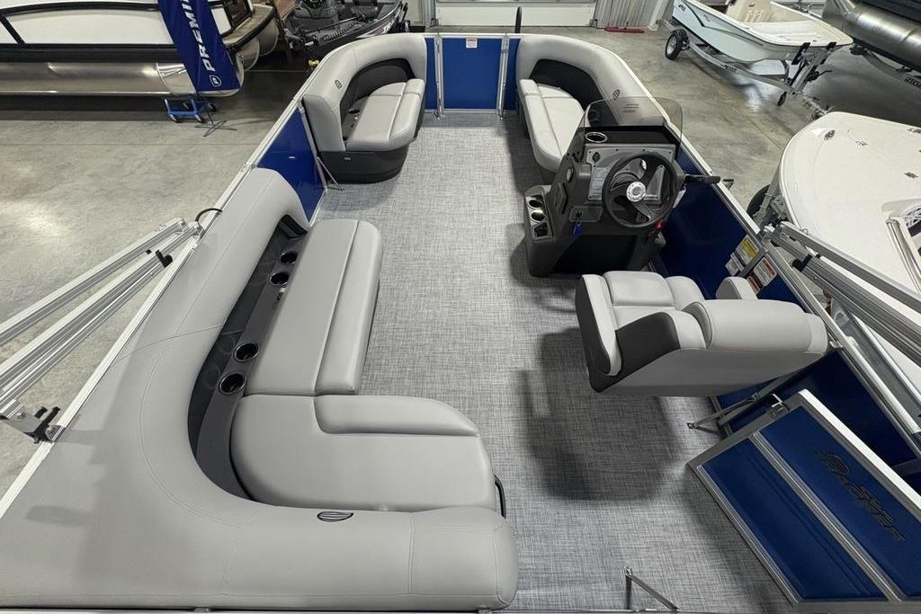 2026 Sun Tracker Party Barge 16 DLX interior with gray seating and steering console.