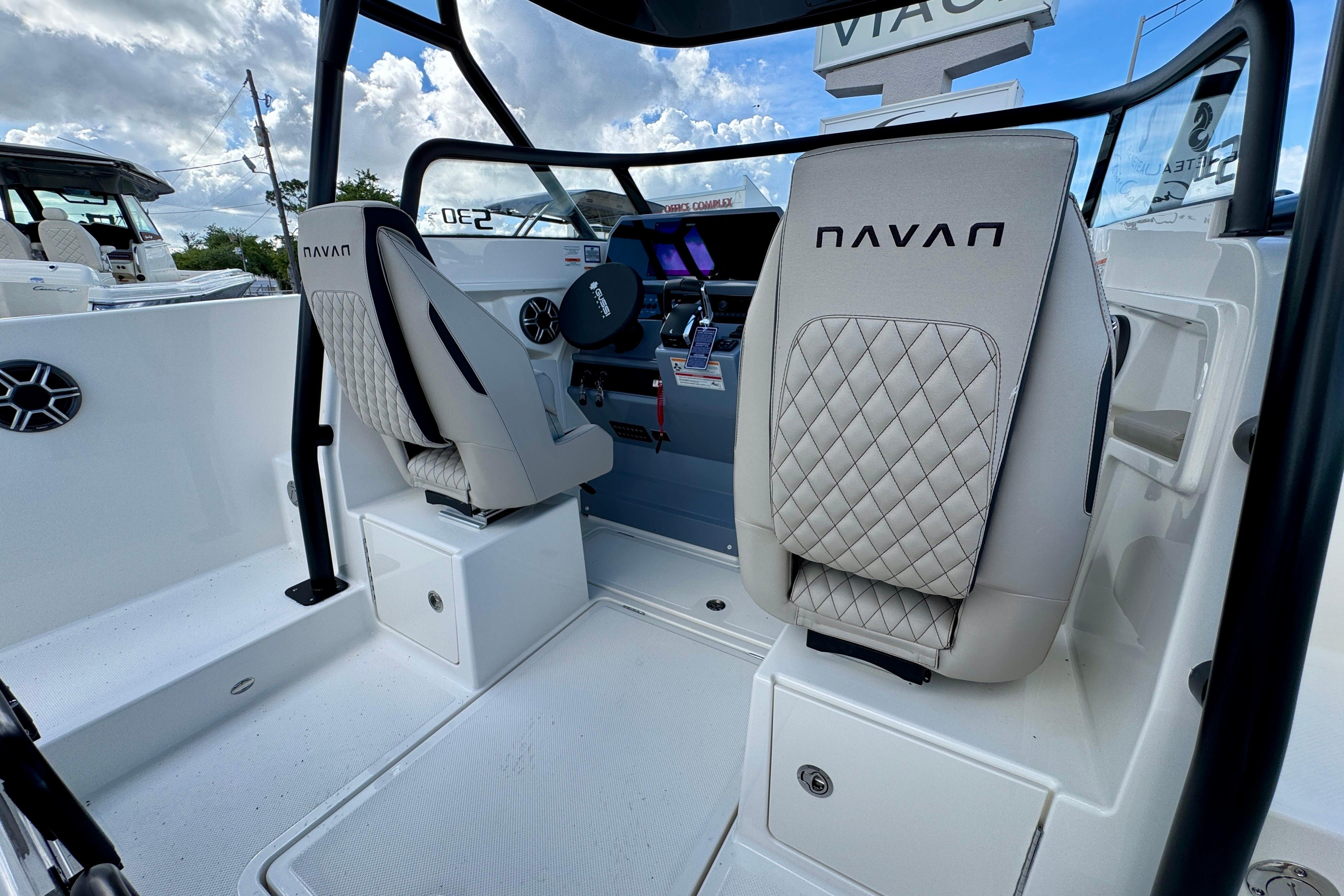 Interior of 2026 Navan S30 boat with modern seating and steering console.