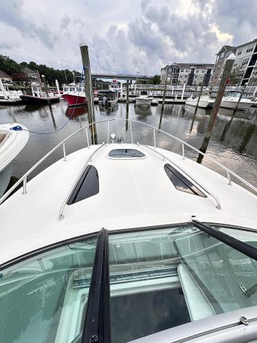 2015 Sea Ray 260 Sundancer docked at a marina with cloudy skies.