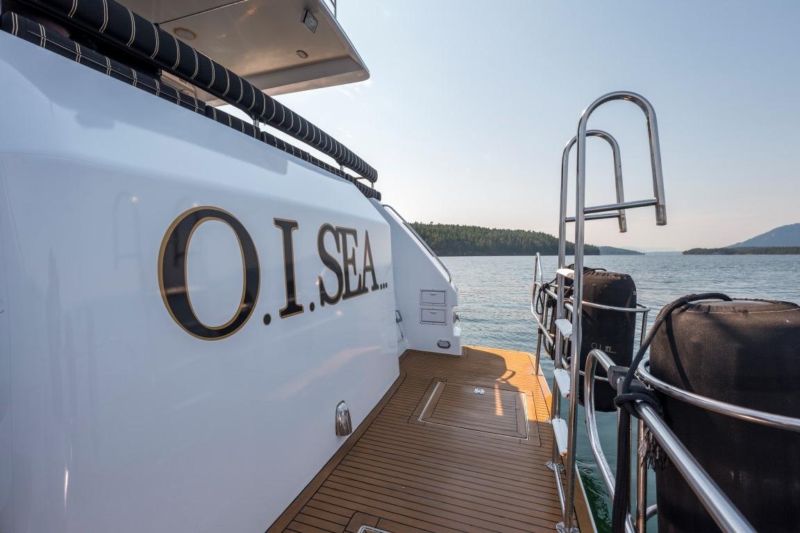 Forbes Cooper 73 yacht, 1996 model, with "O.I. SEA" name, docked by scenic waters.