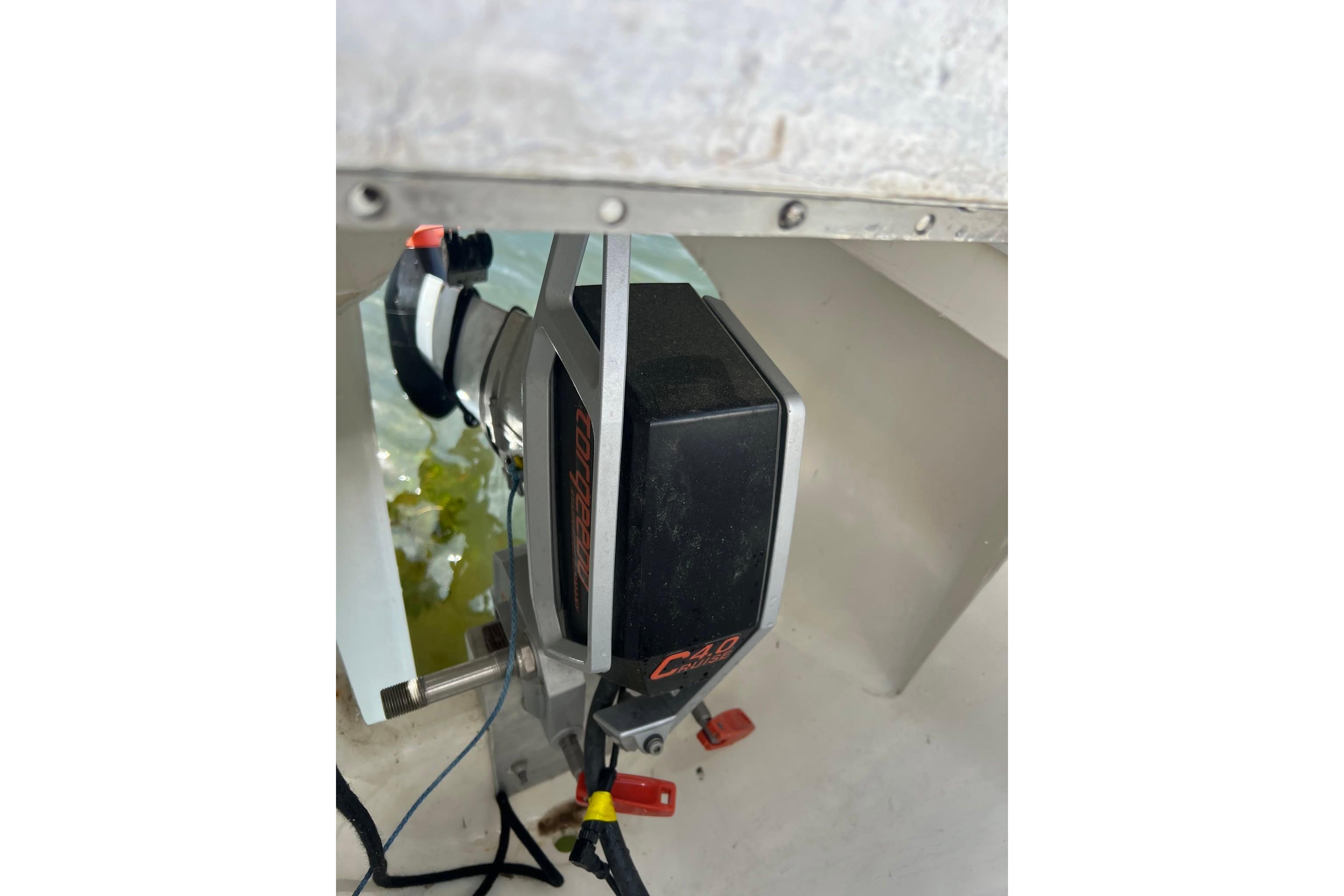 Close-up of a 1993 Corsair F-27 boat motor component in a white interior setting.