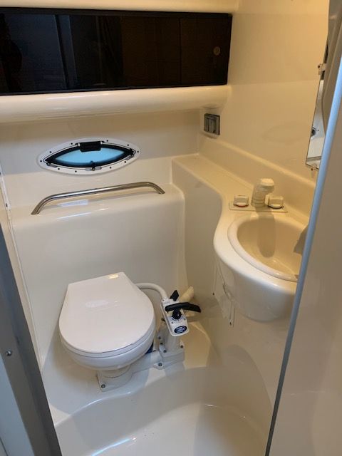 Interior of Bayliner 2855 yacht, bathroom with toilet and sink.