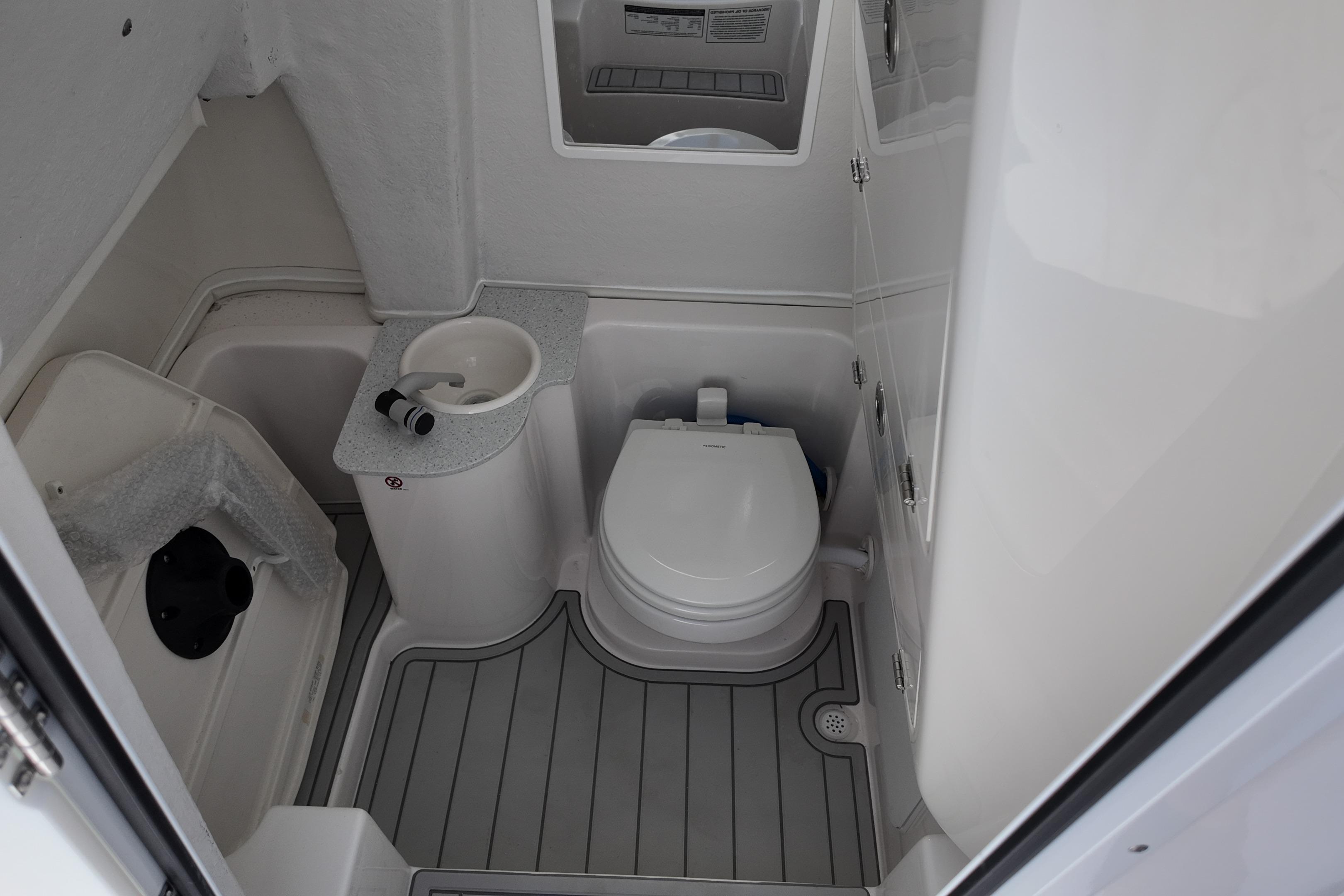 2026 Sea Fox 268 Commander boat bathroom with toilet and sink.
