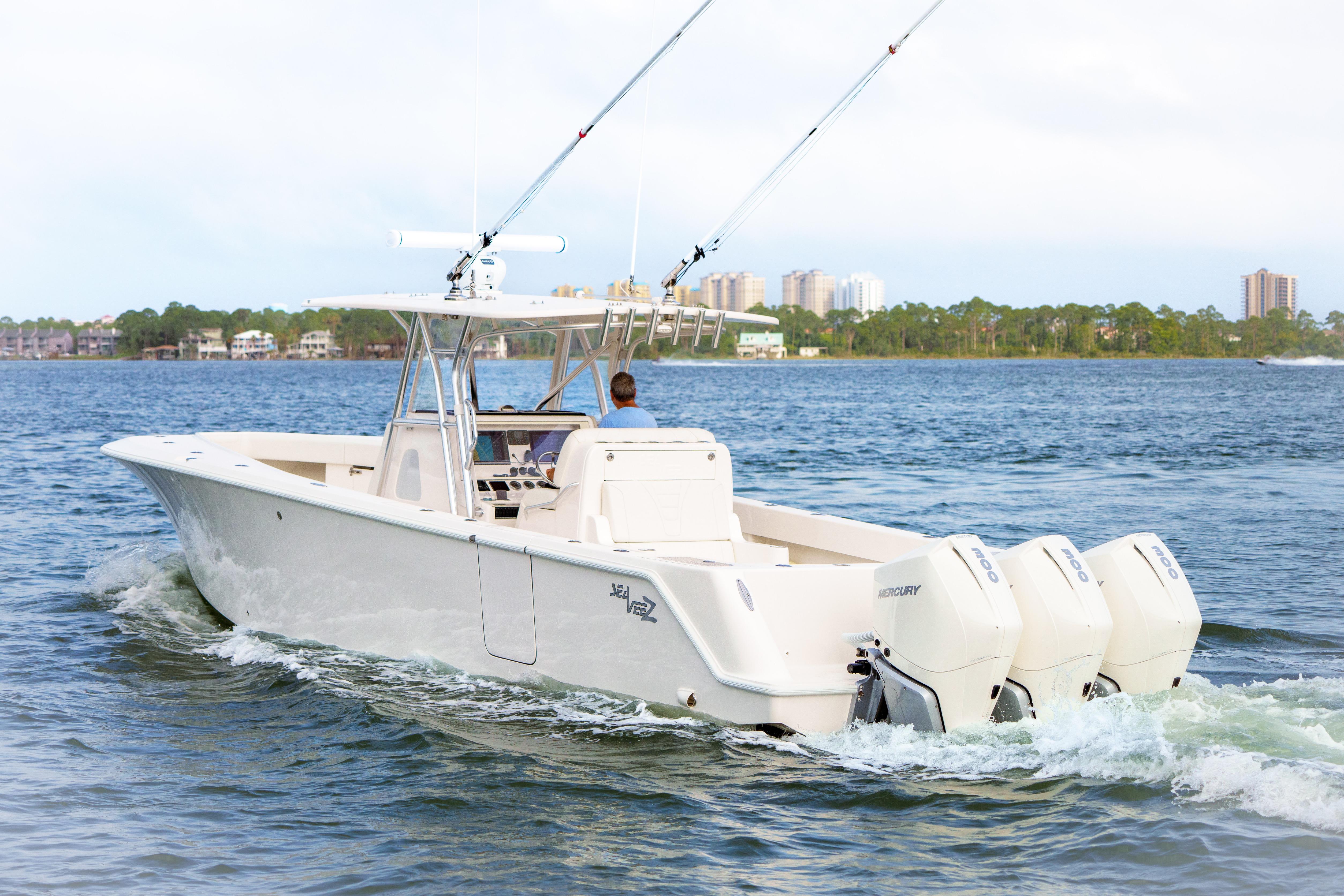 2022 SeaVee 370Z boat cruising on water with triple Mercury engines.