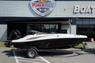 2024 Tahoe T18 boat on trailer outside dealership.