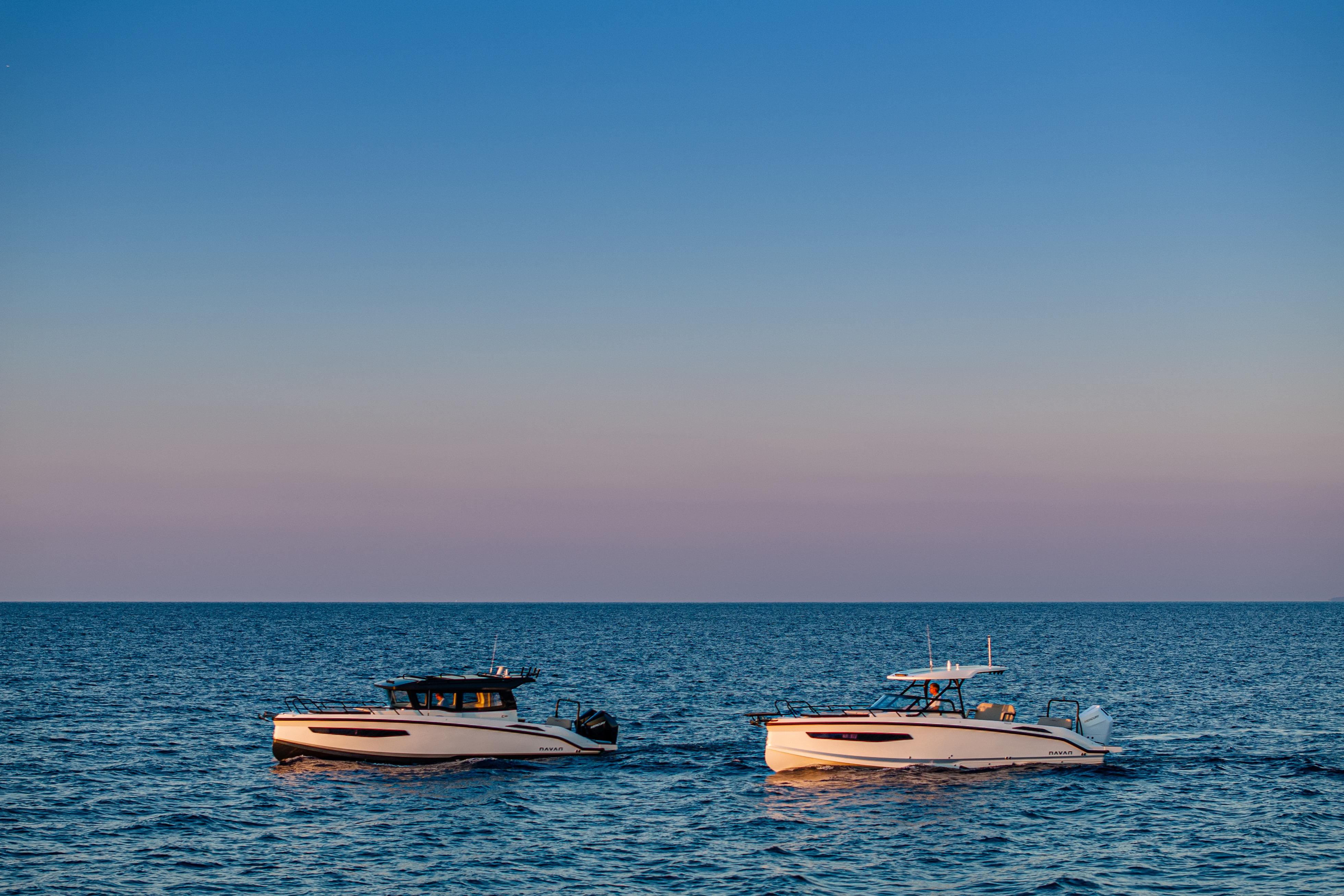 Two Navan S30 boats on calm sea at sunset, 2026 model.
