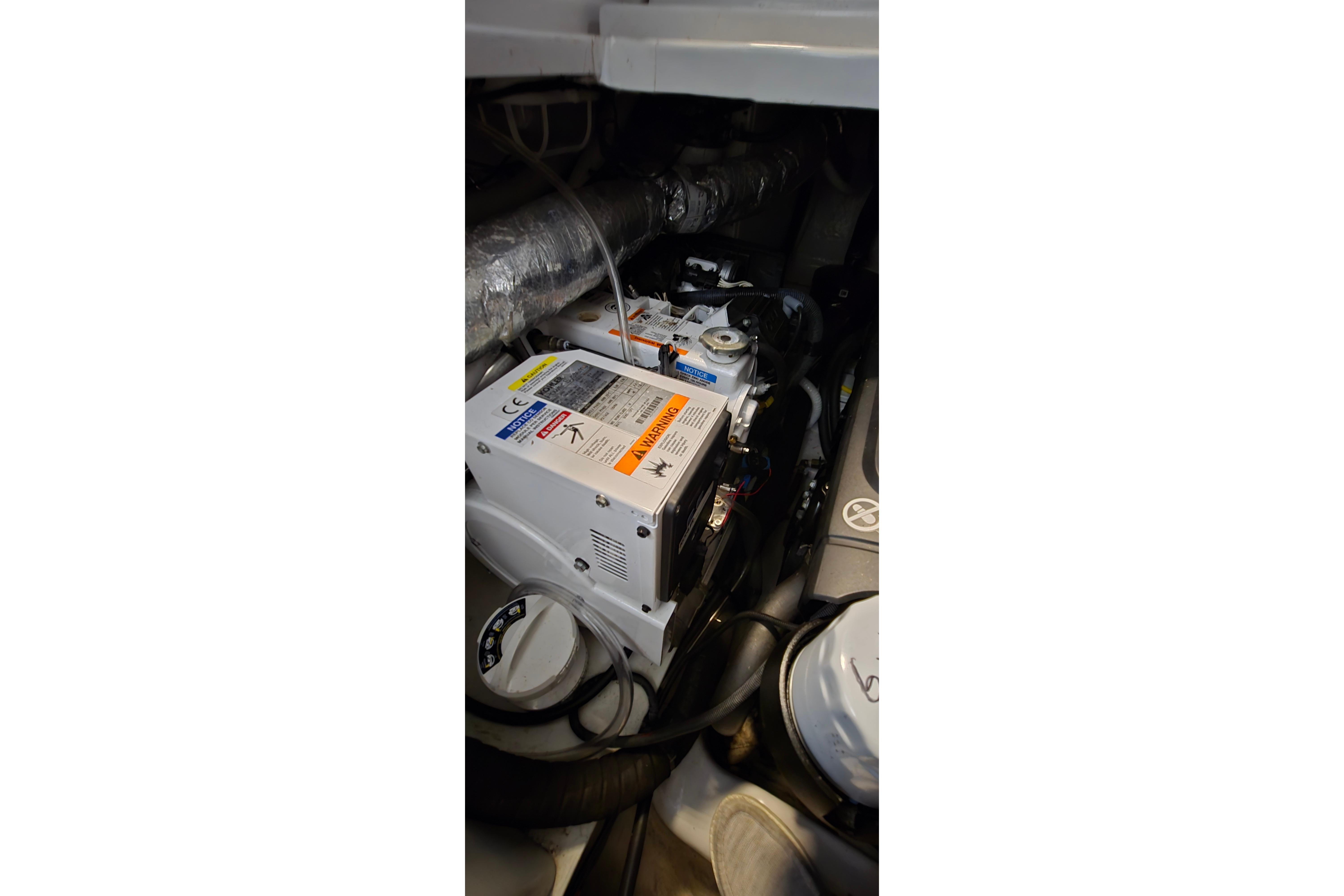 Engine compartment of a 2018 Four Winns V355 boat, showcasing mechanical components.