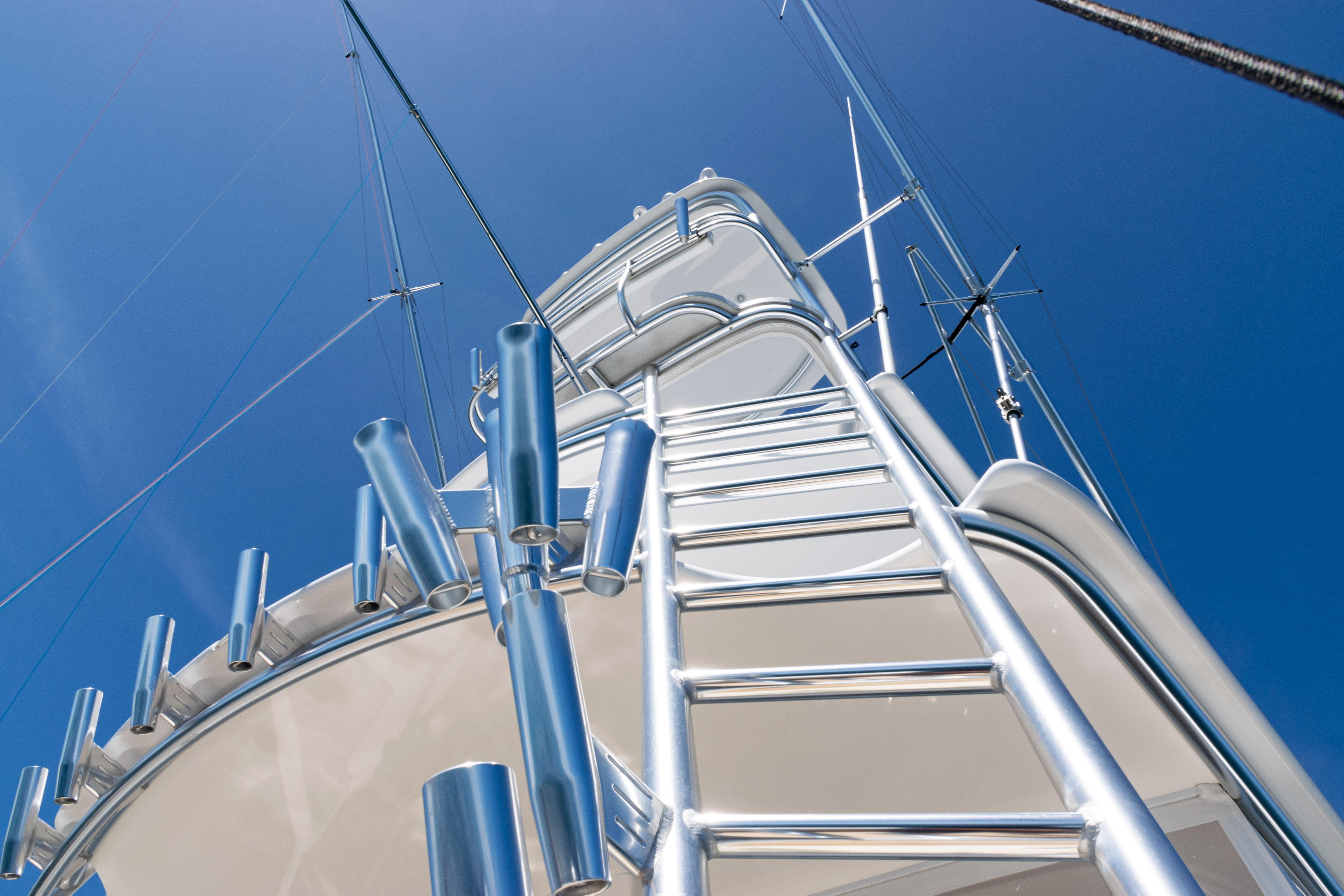 2021 Viking 44 Open yacht tower with ladder against clear blue sky.
