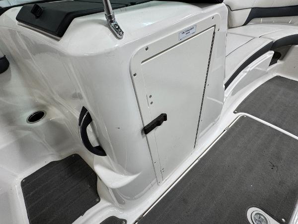 2014 Yamaha Boats 212X interior, featuring storage compartment and seating area.
