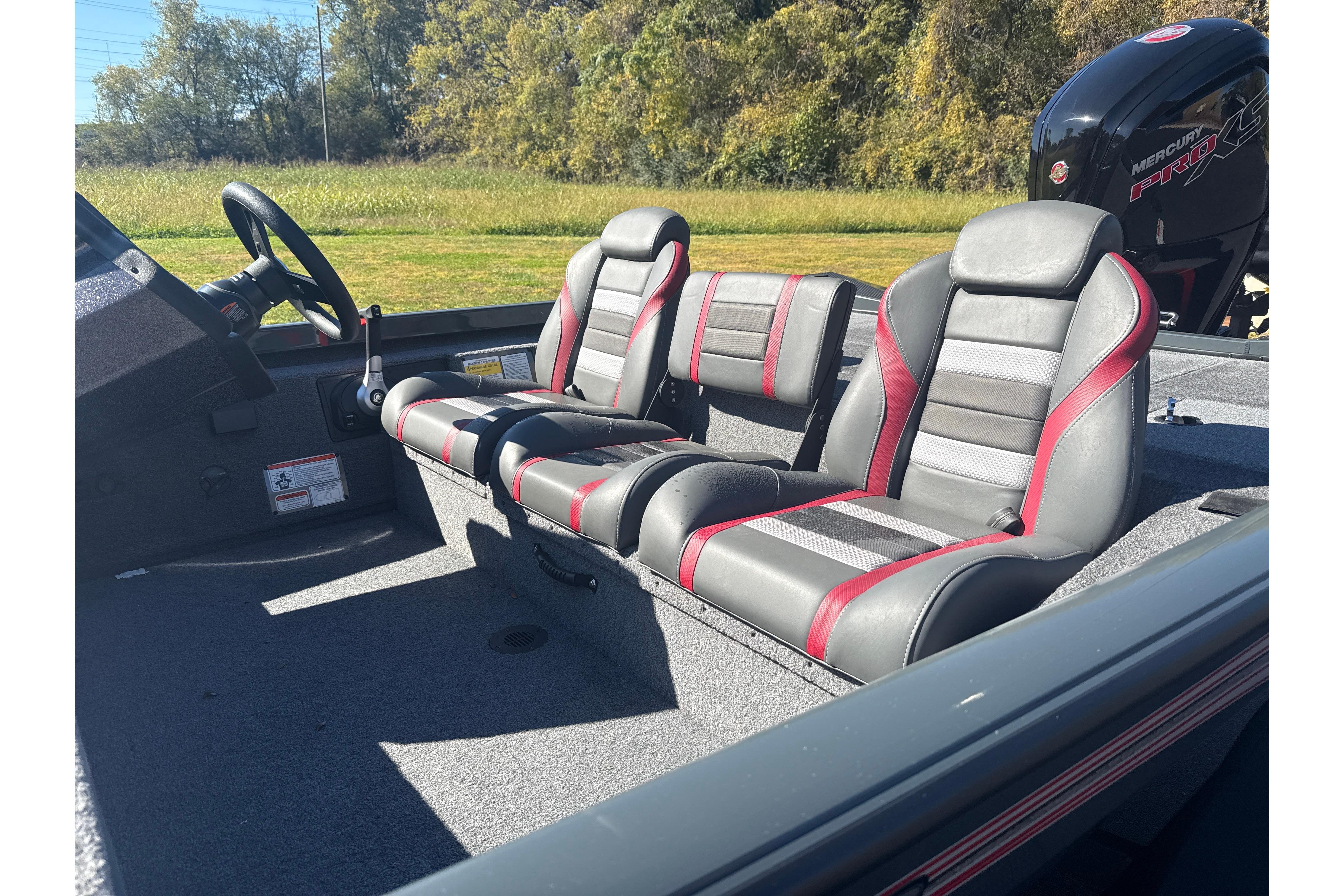 2025 Ranger RT188 boat interior with gray and red seats, steering wheel, and Mercury engine.