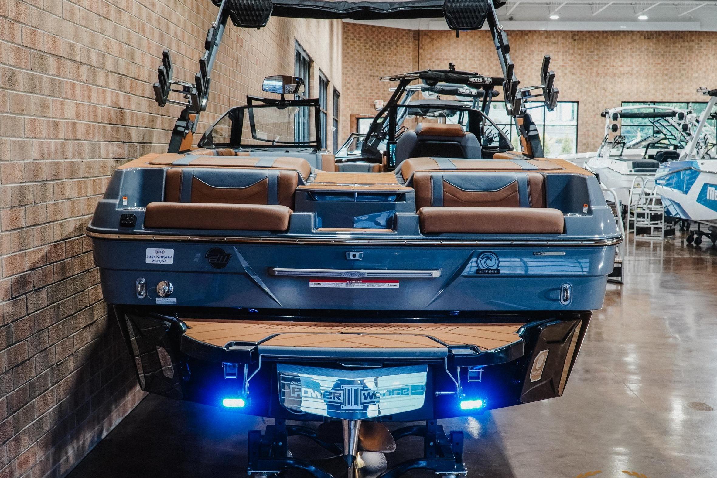 2026 Malibu Wakesetter 23 LSV boat in showroom, rear view with sleek design and modern features.