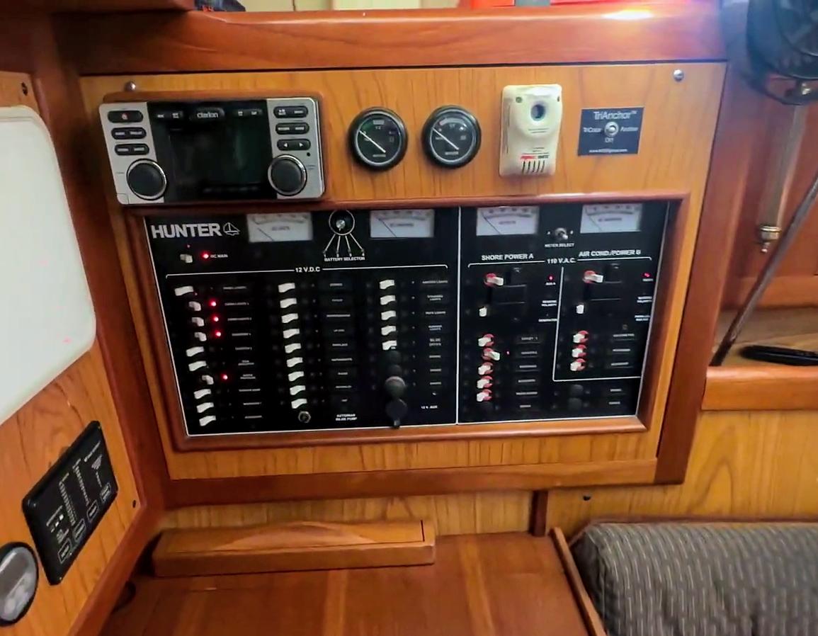 Control panel of a 2001 Hunter 380 sailboat with various switches and gauges.