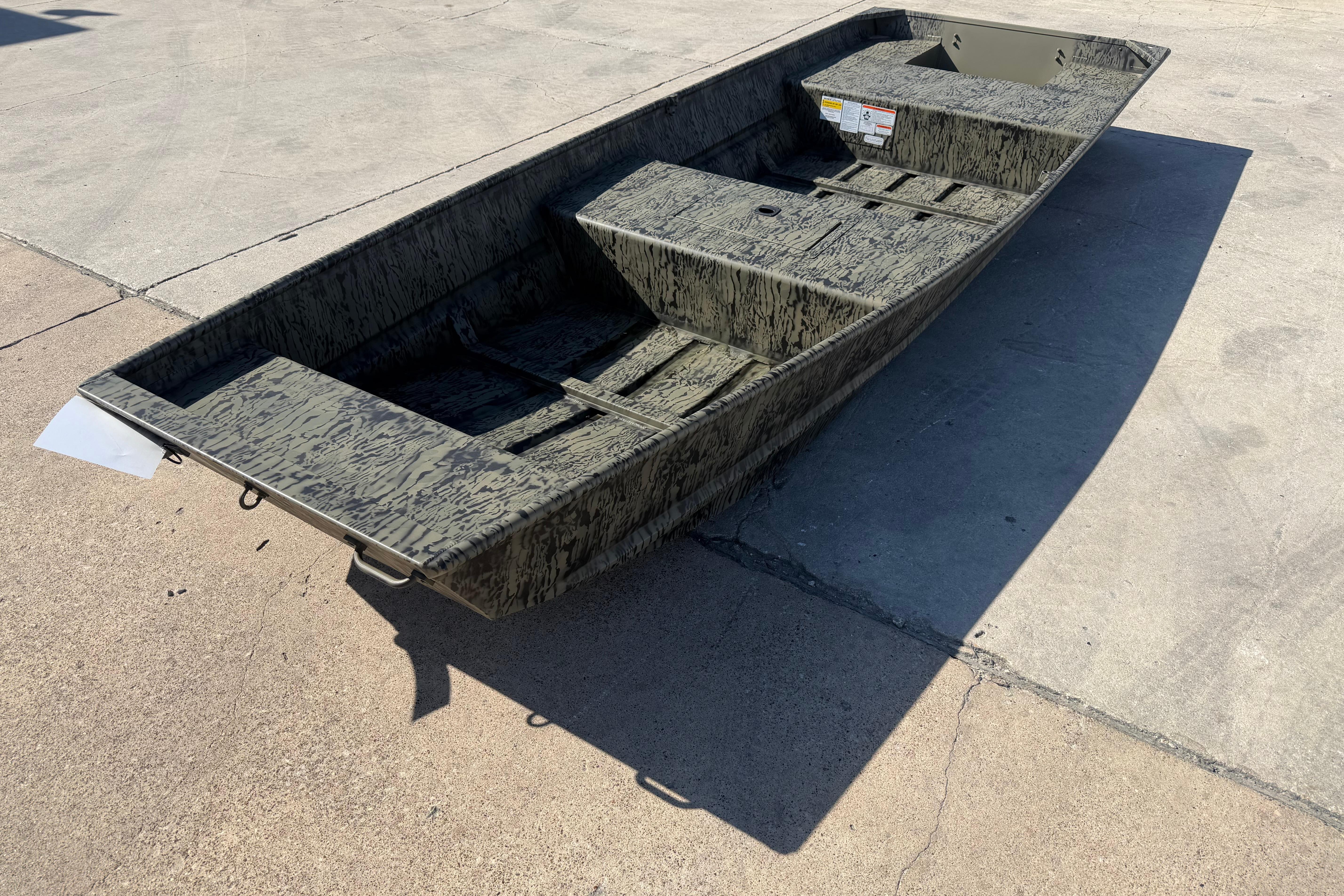 2026 Tracker Grizzly 15 Jon boat on concrete surface, showcasing rugged design.