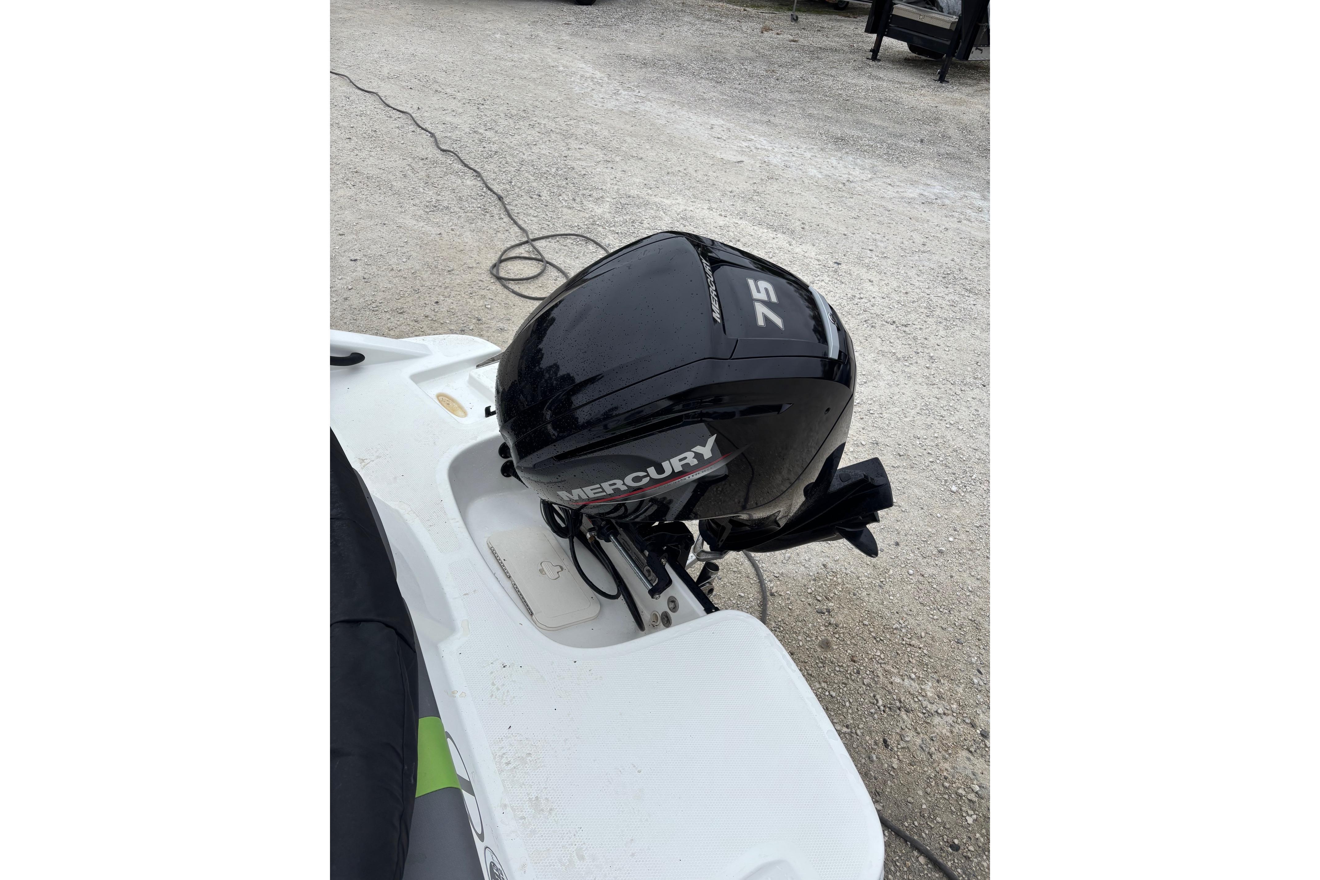 2022 Tahoe T16 boat with Mercury 75 outboard motor on a gravel surface.