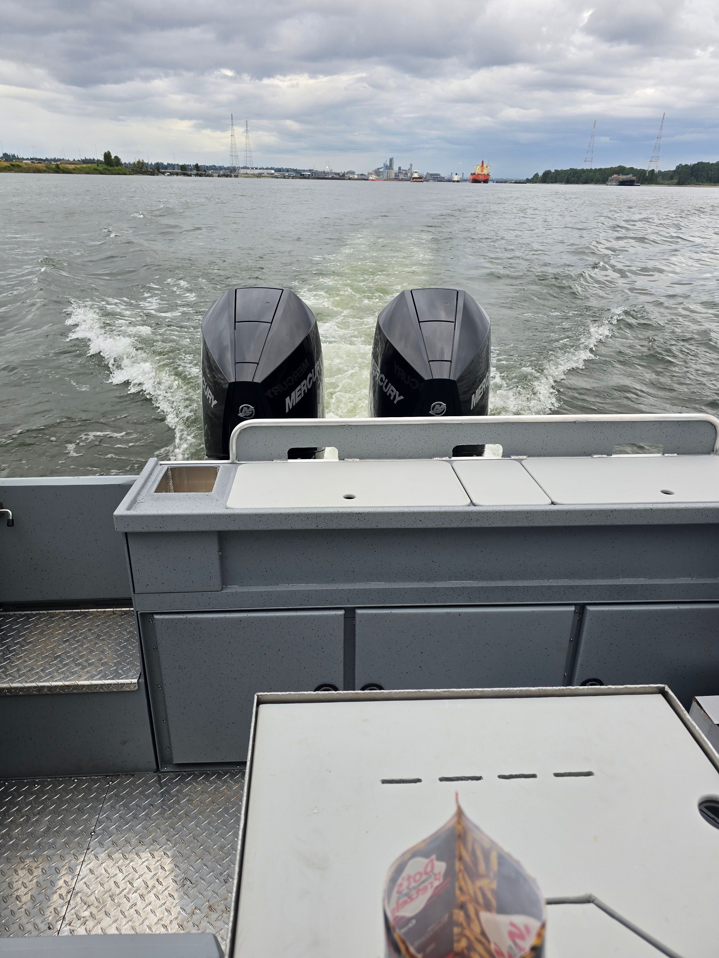 Boat with twin Mercury engines on water, 2025 Custom Alaskan Explorer.