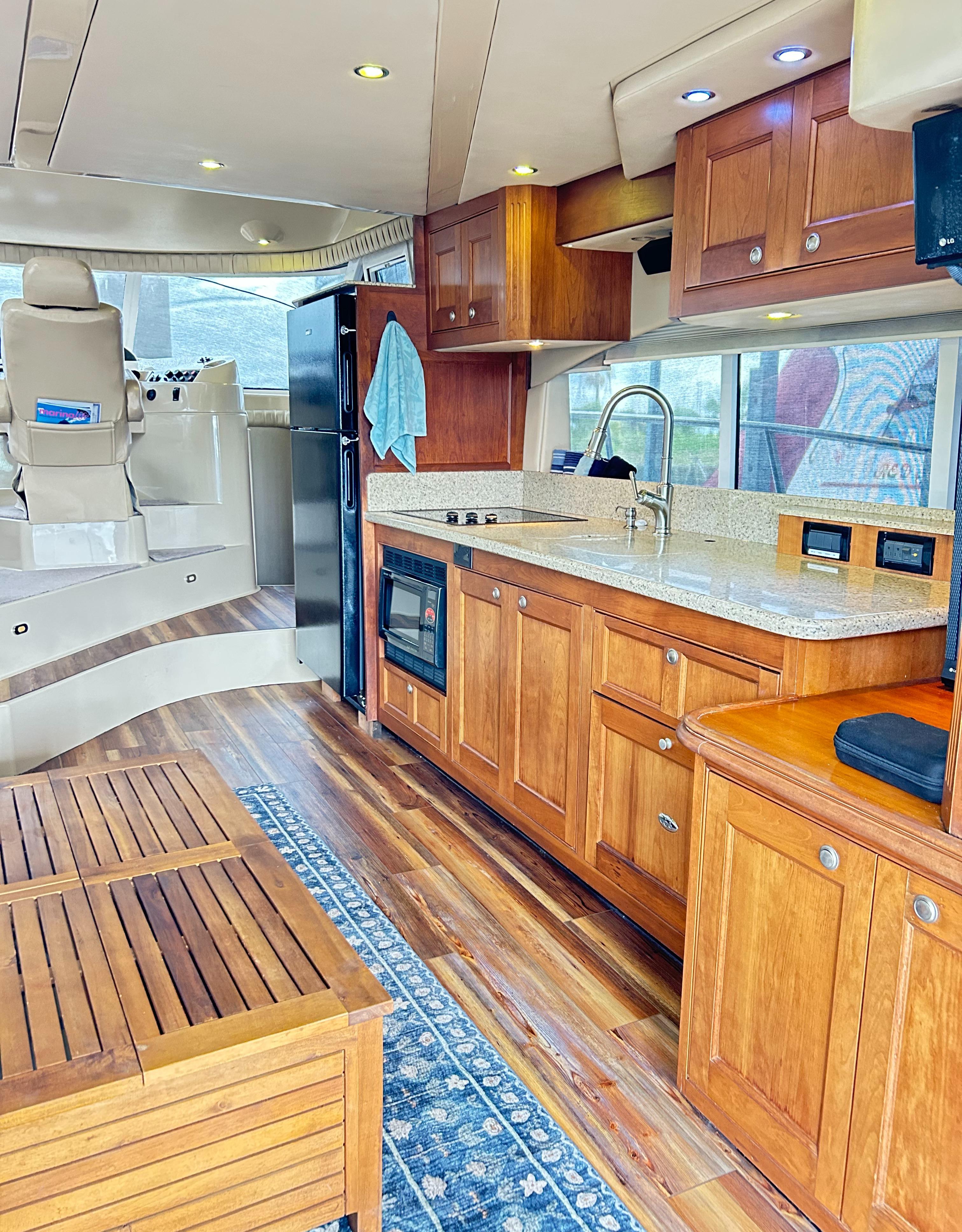 2004 Cruisers Yachts 5000 Sedan Sport interior with wood cabinetry and modern kitchen amenities.