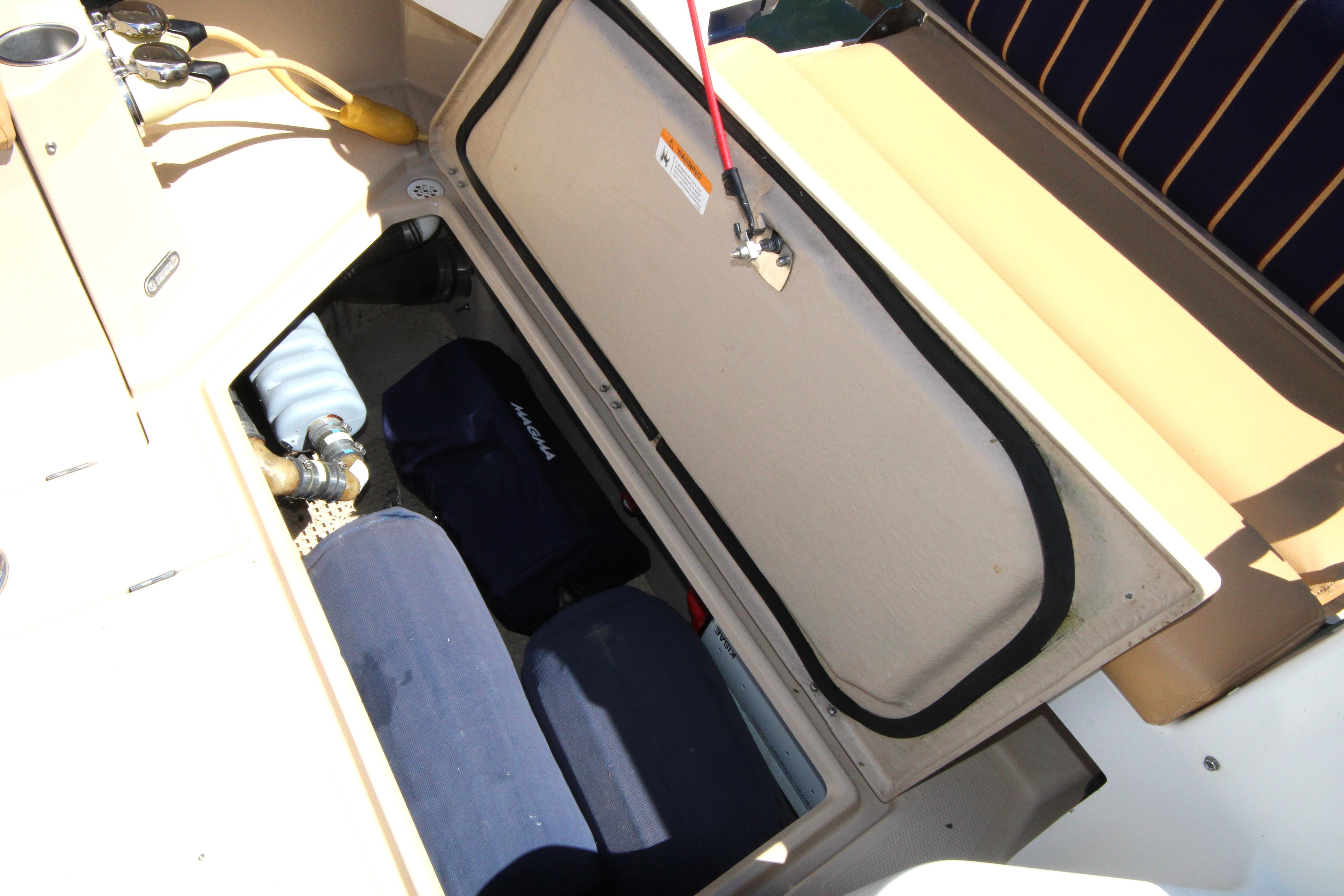 Open storage compartment on 2013 Ranger Tugs R-31 CB boat, showing interior equipment.