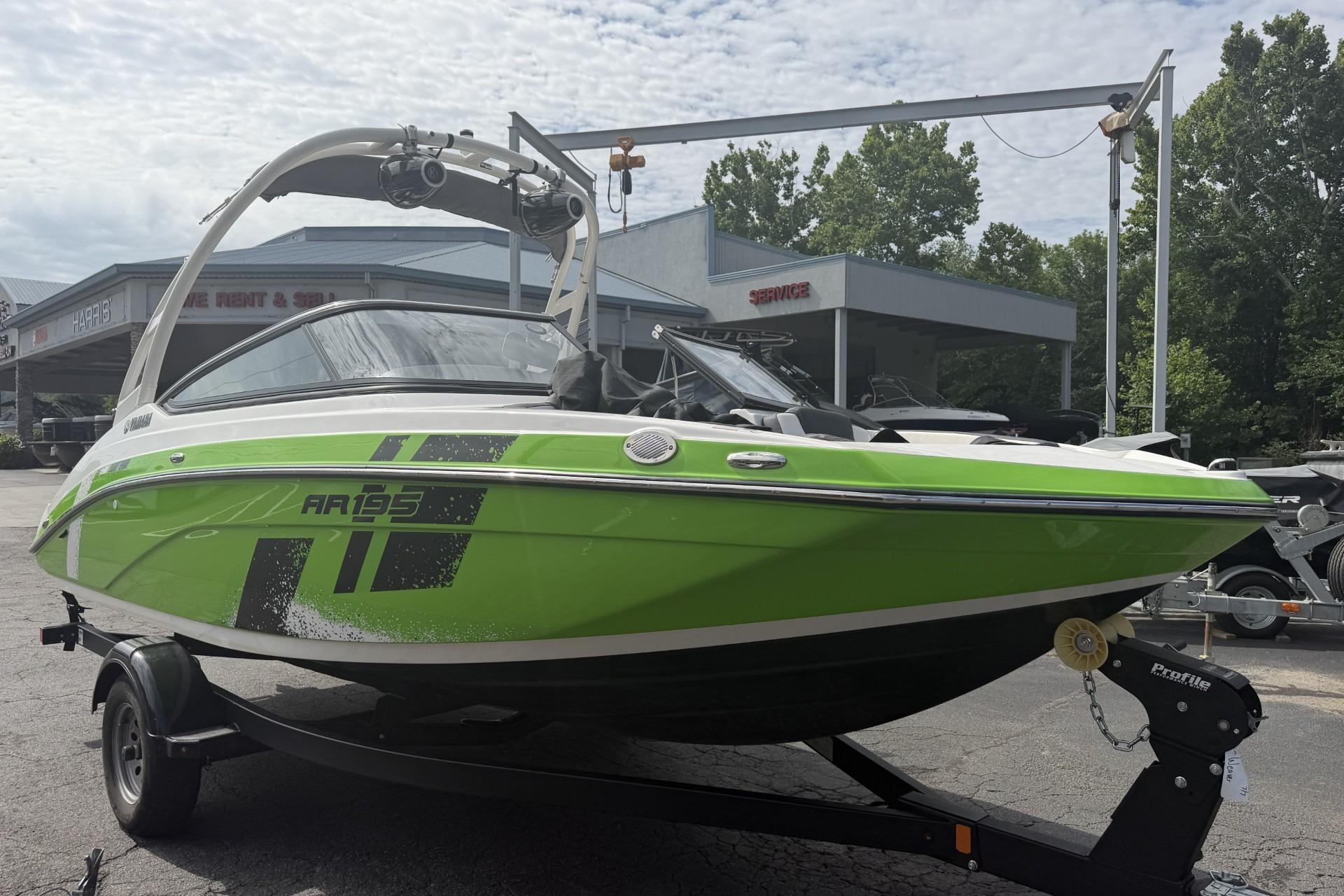 2022 Yamaha Boats AR195 in vibrant green on trailer, parked outdoors.