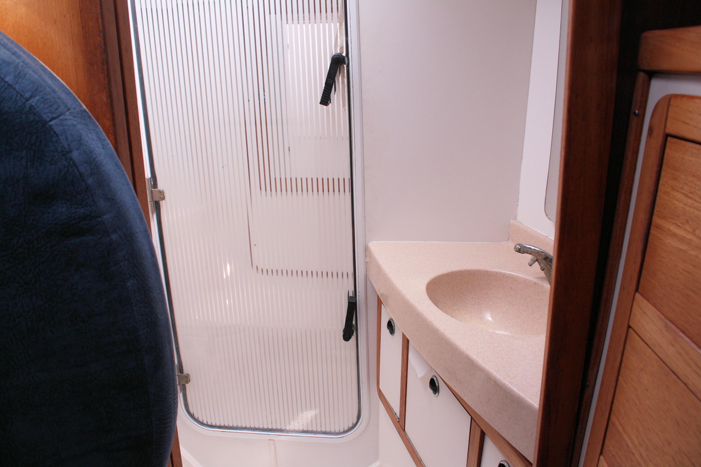 Bathroom interior of a 1998 Catalina 42 MkII yacht, featuring a sink and shower area.