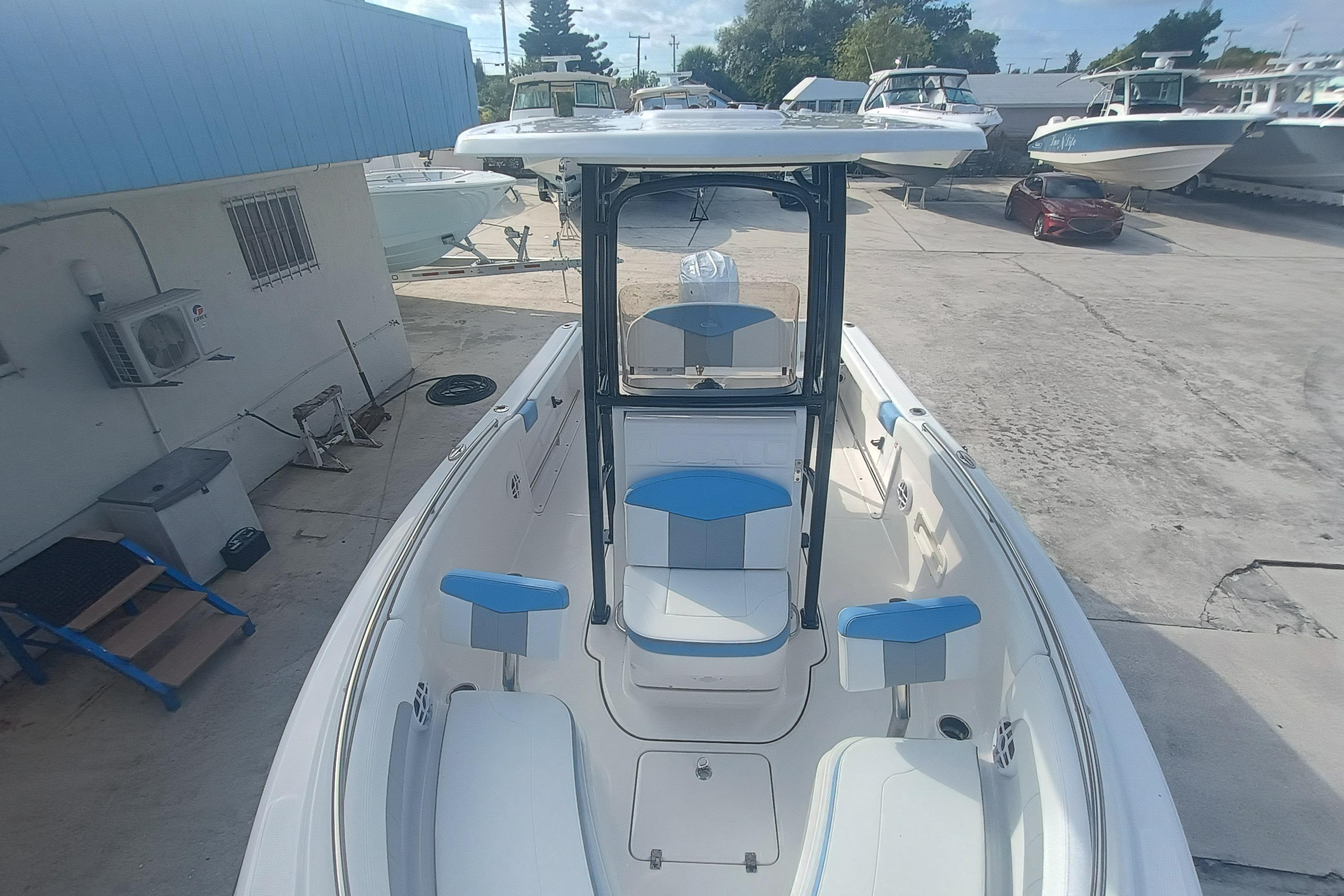 2026 Robalo R222 Explorer boat with blue and white seating, docked outdoors.