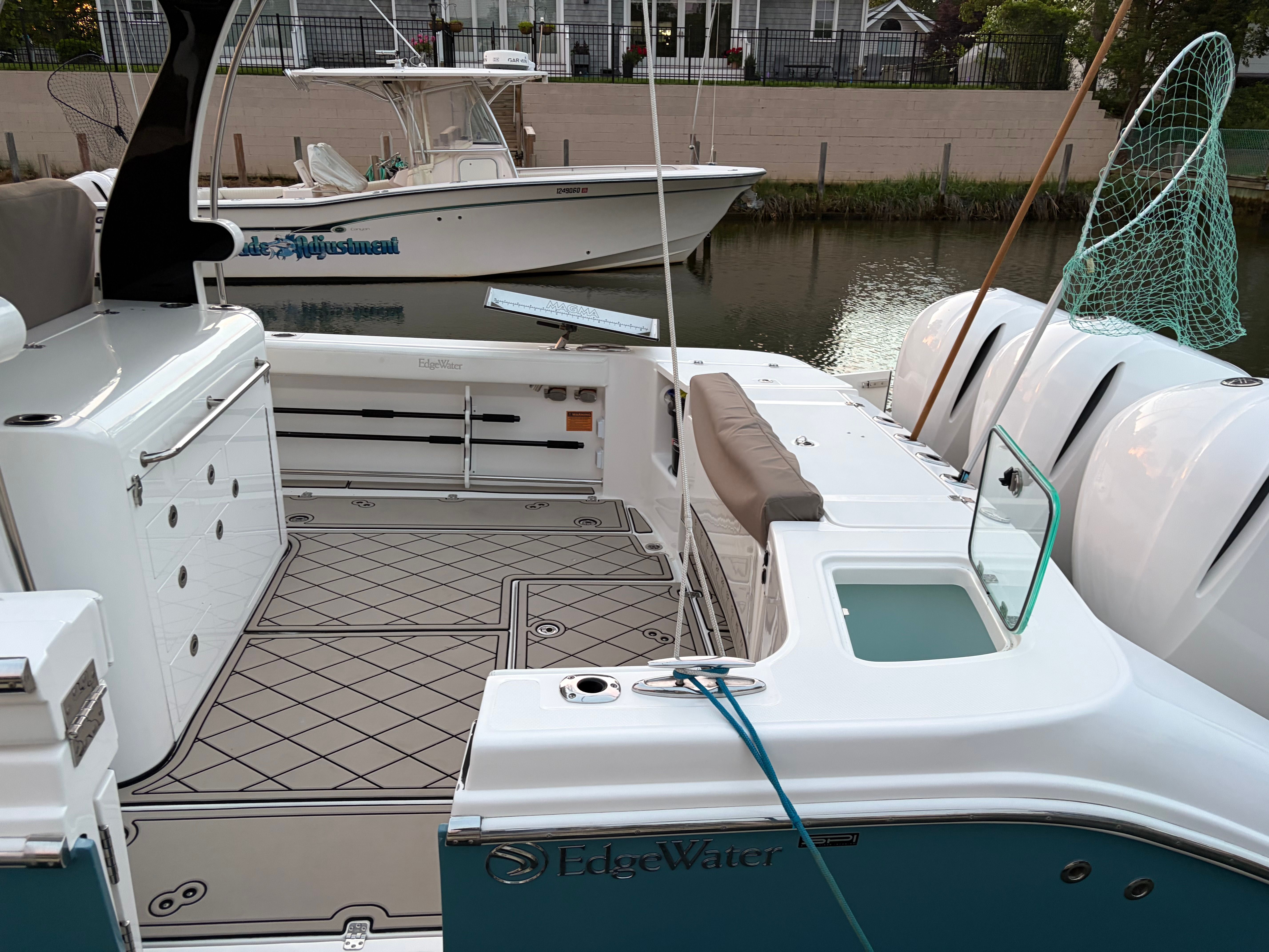 2019 Edgewater 370CC boat docked by the water.