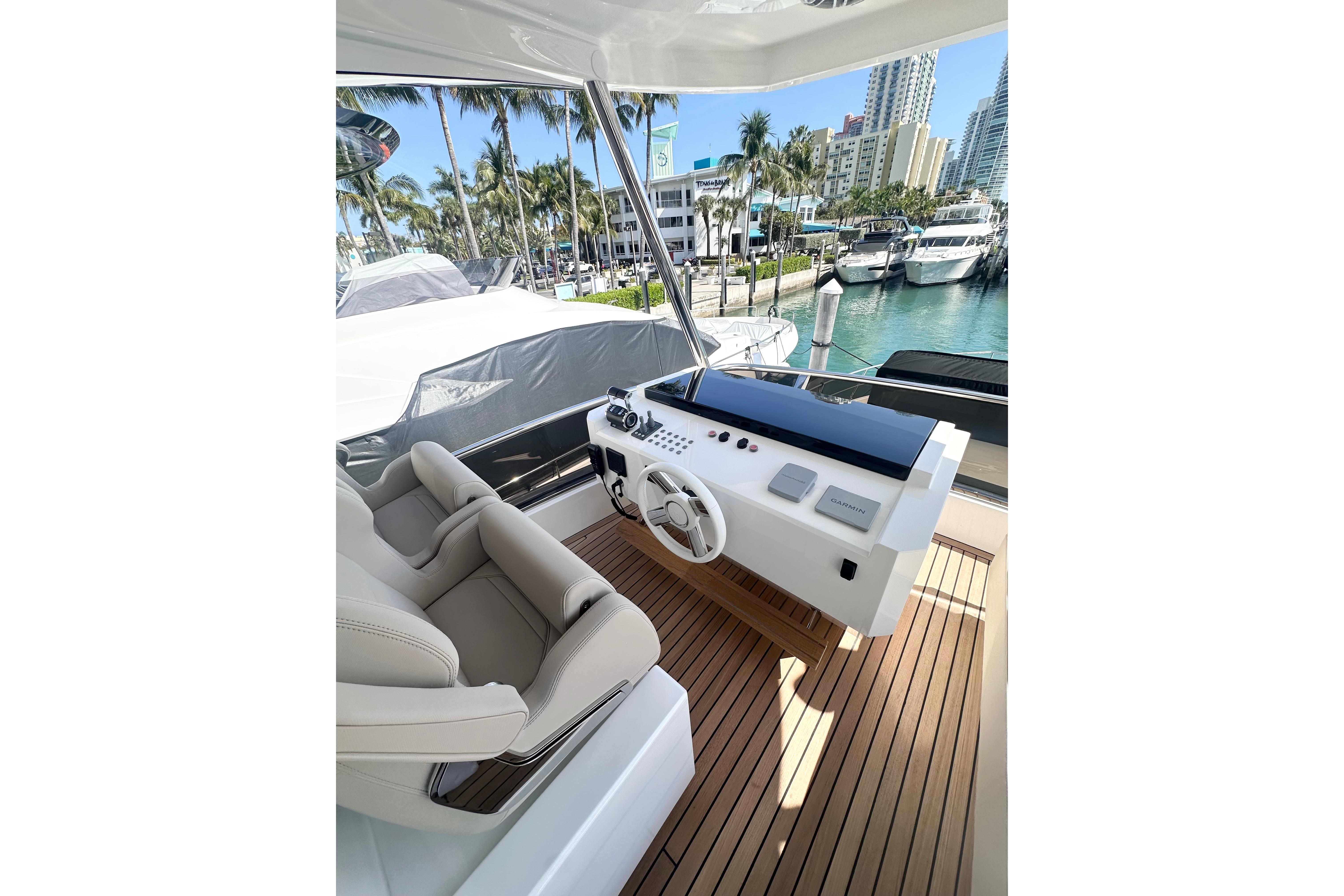 Luxurious helm of 2026 Astondoa 66 Fly yacht with modern controls and seating.