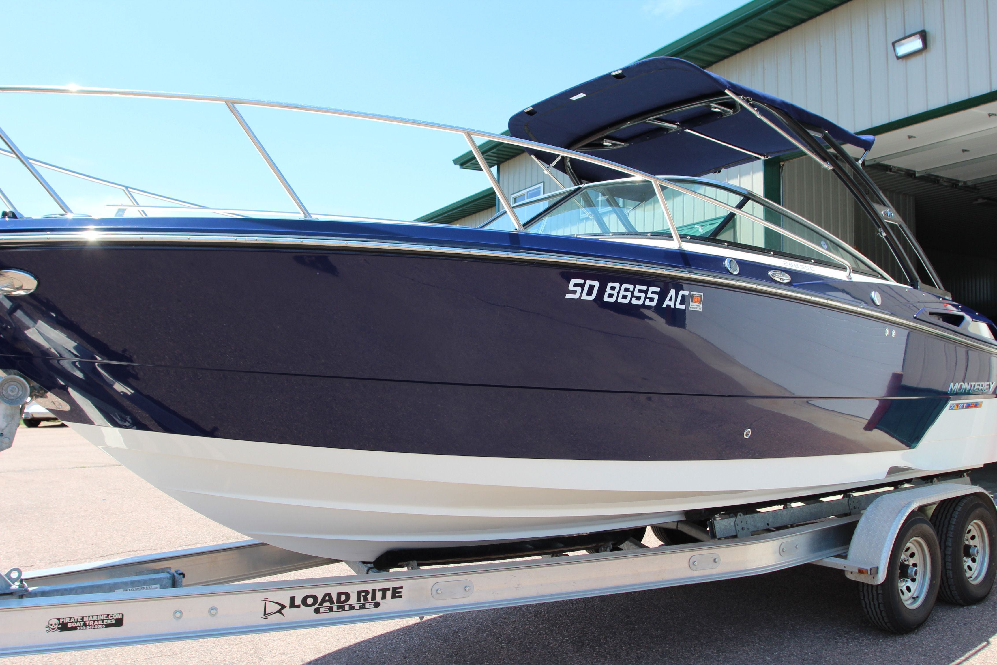 2015 Monterey 268SSC boat on trailer outside building.