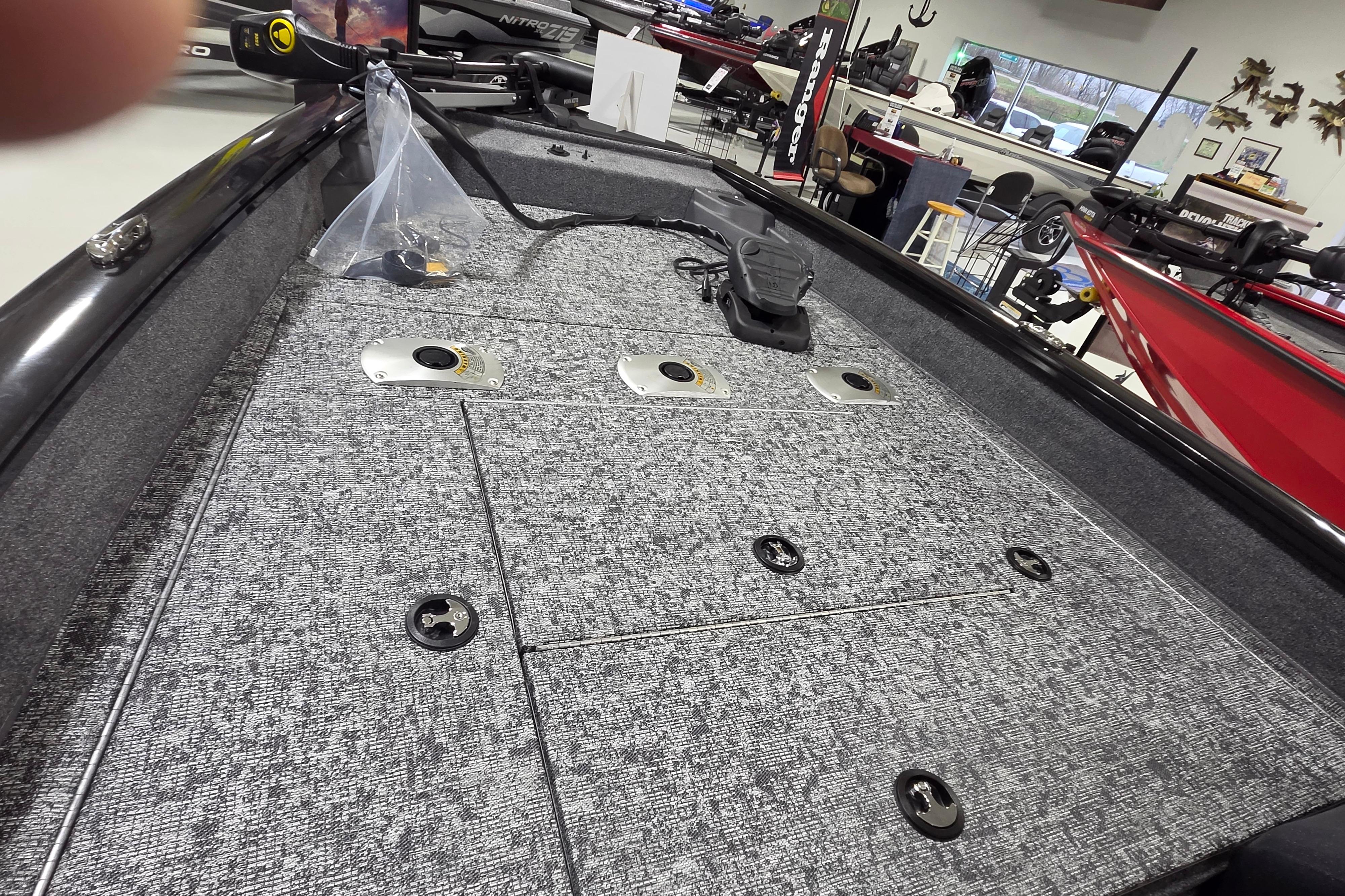 2026 Tracker Pro Team 175 Crappie Edition boat interior with carpeted deck and fishing equipment.