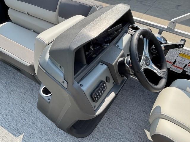 2026 Sun Tracker Fishin' Barge 20 DLX dashboard and steering wheel, featuring modern controls.