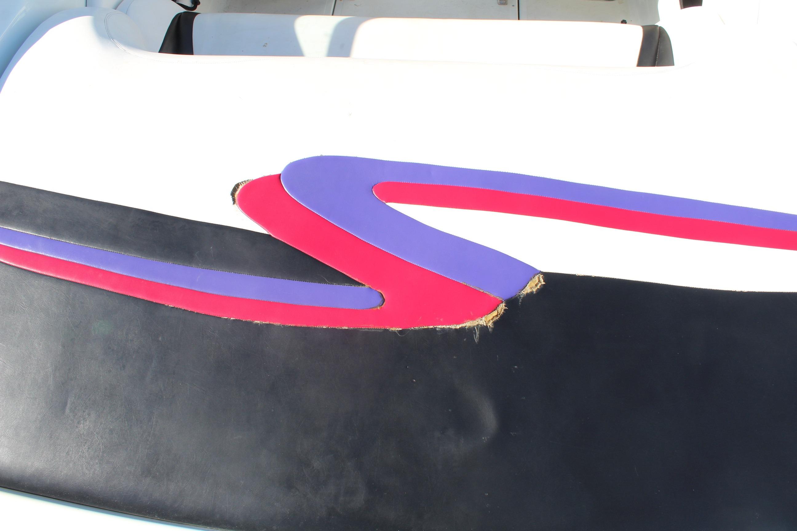 1996 Baja 232 boat seat with colorful design and visible tear.