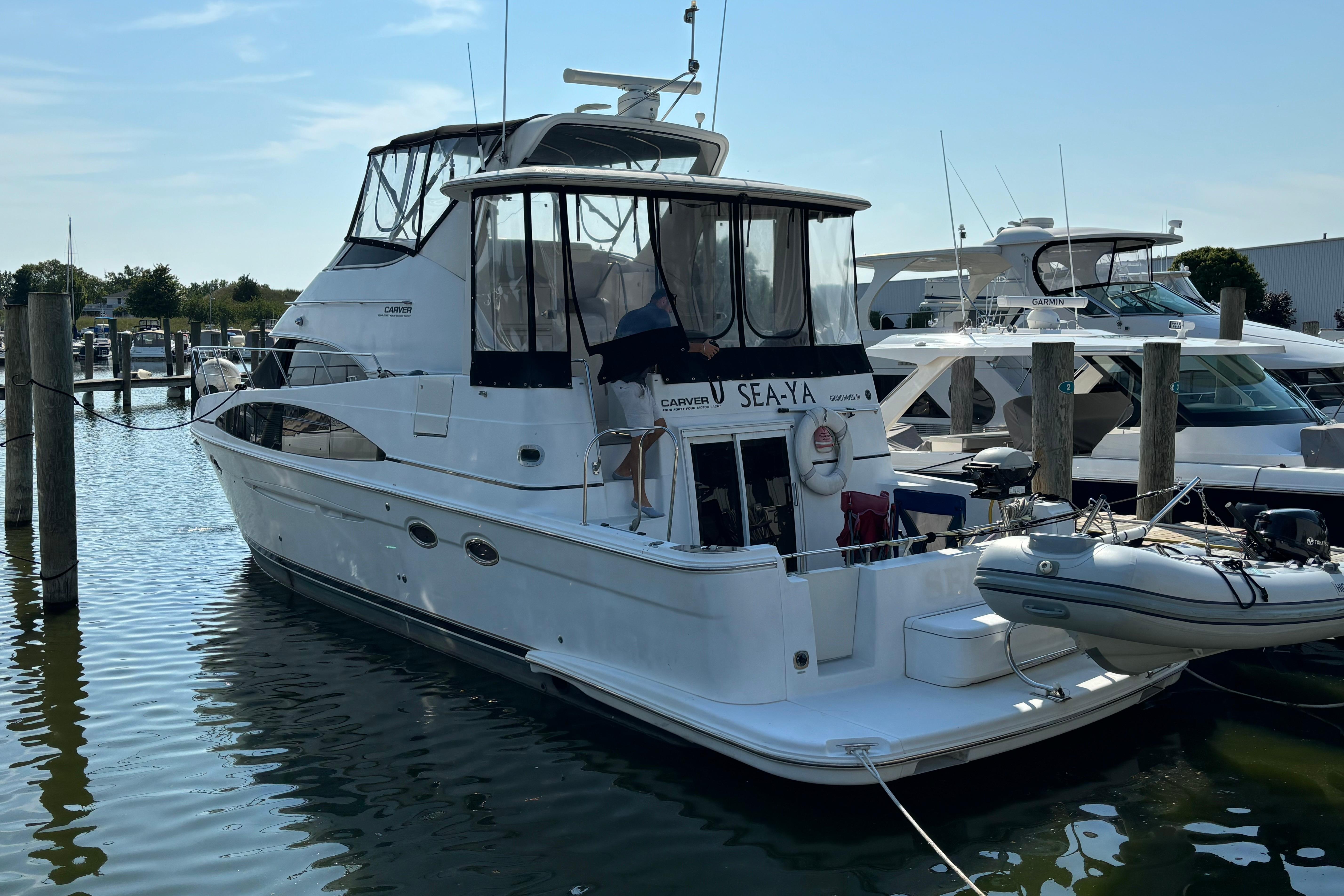 2002 Carver 444 Cockpit Motor Yacht docked at marina, rear view.