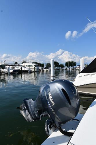 2021 Eastern 248 Center Console boat with Yamaha outboard motor docked at marina.