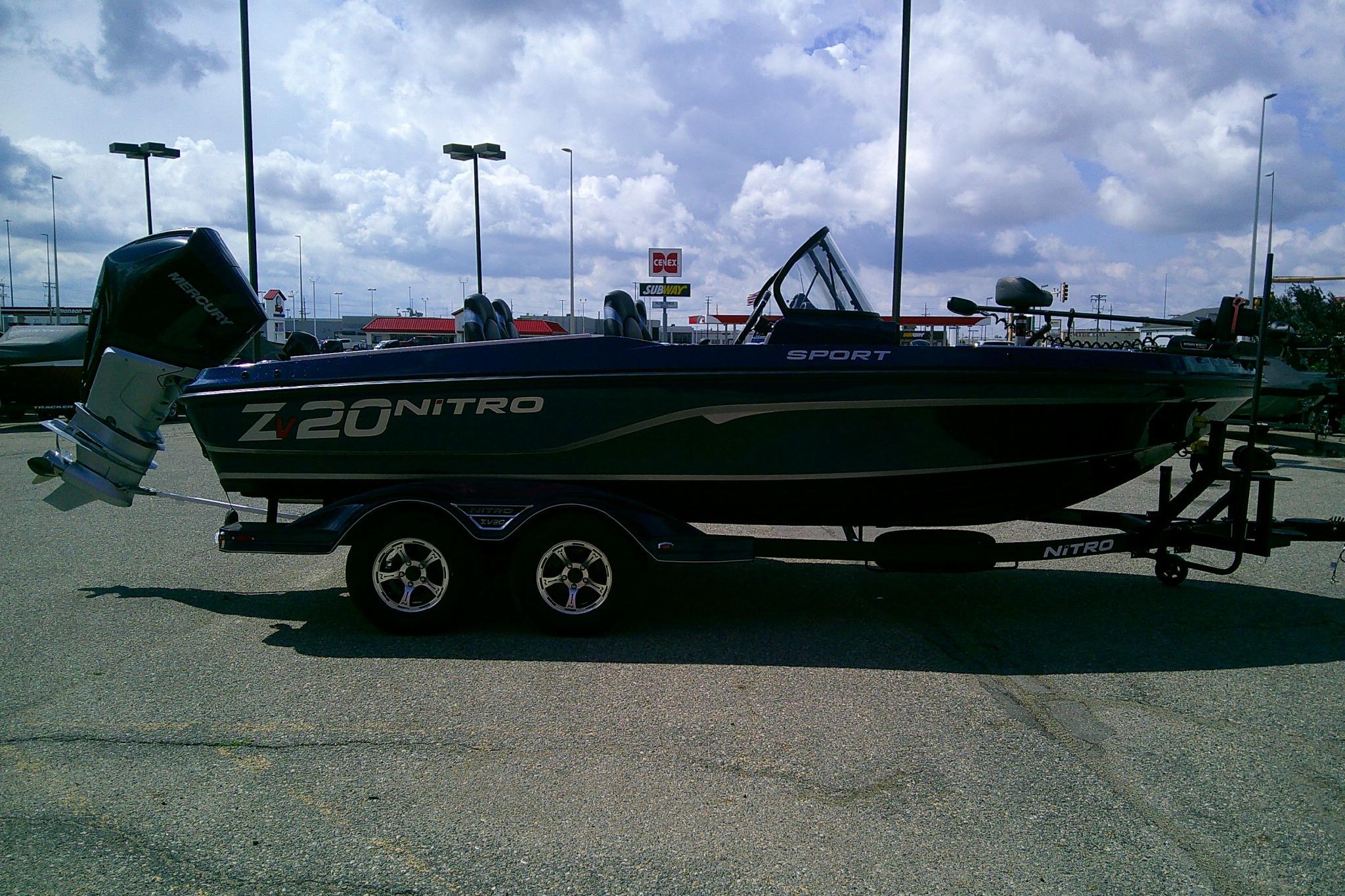 2025 Nitro ZV20 Sport boat on trailer, parked outdoors under cloudy sky.