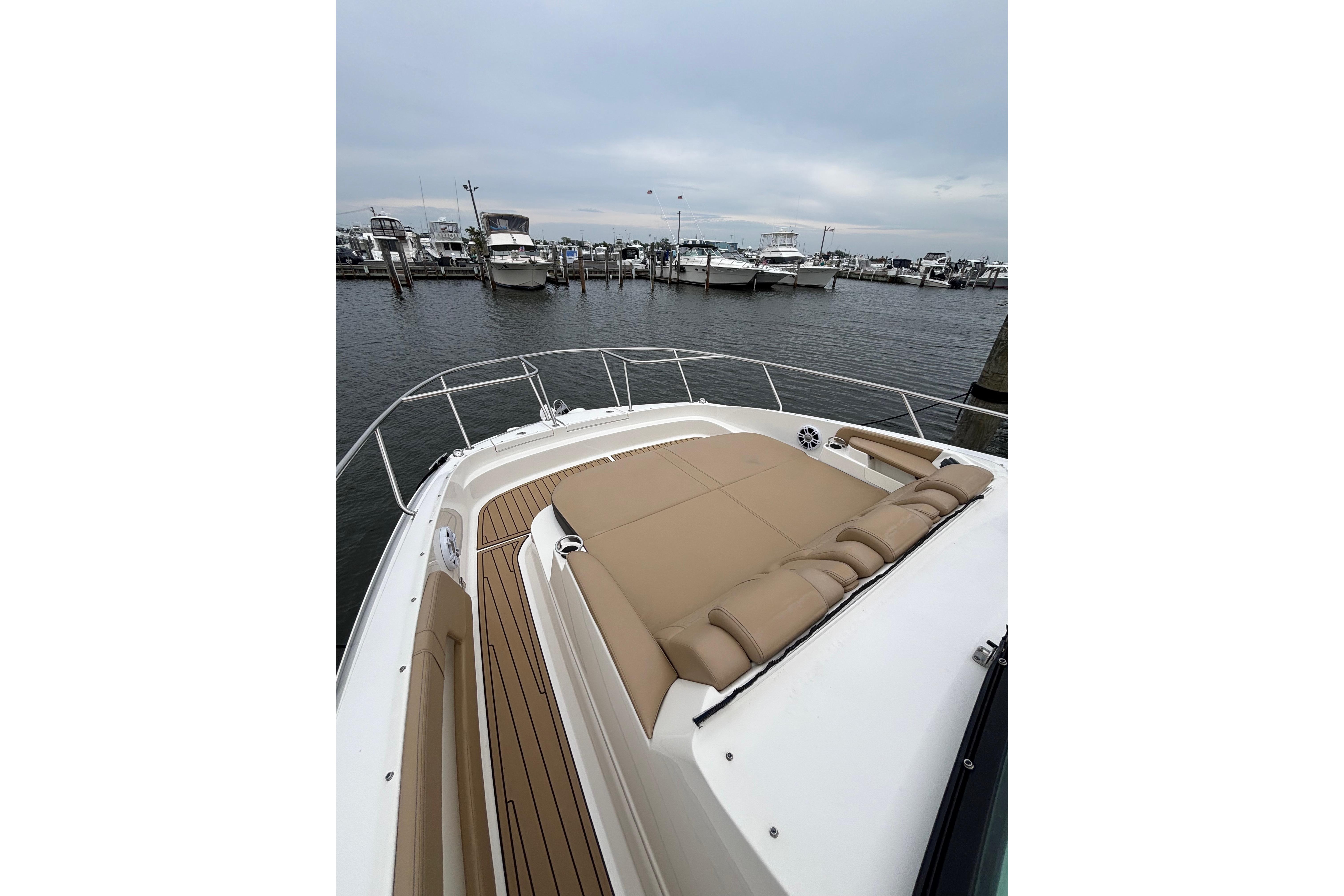 2021 Sea Ray Sundancer 320 Outboard with spacious deck and luxurious seating at marina.