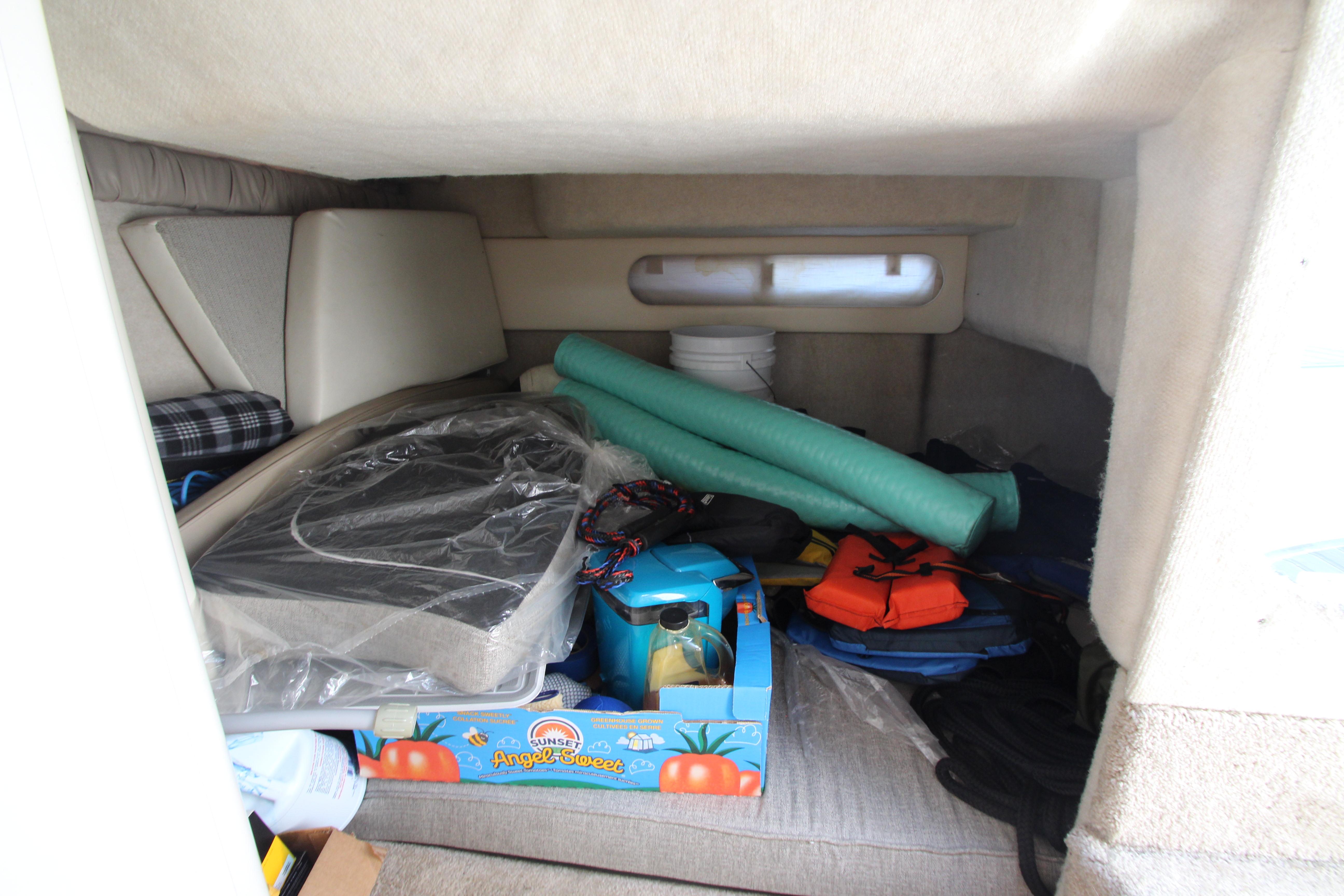 Interior cabin of 1999 Bayliner 3055 Ciera with stored items and equipment.