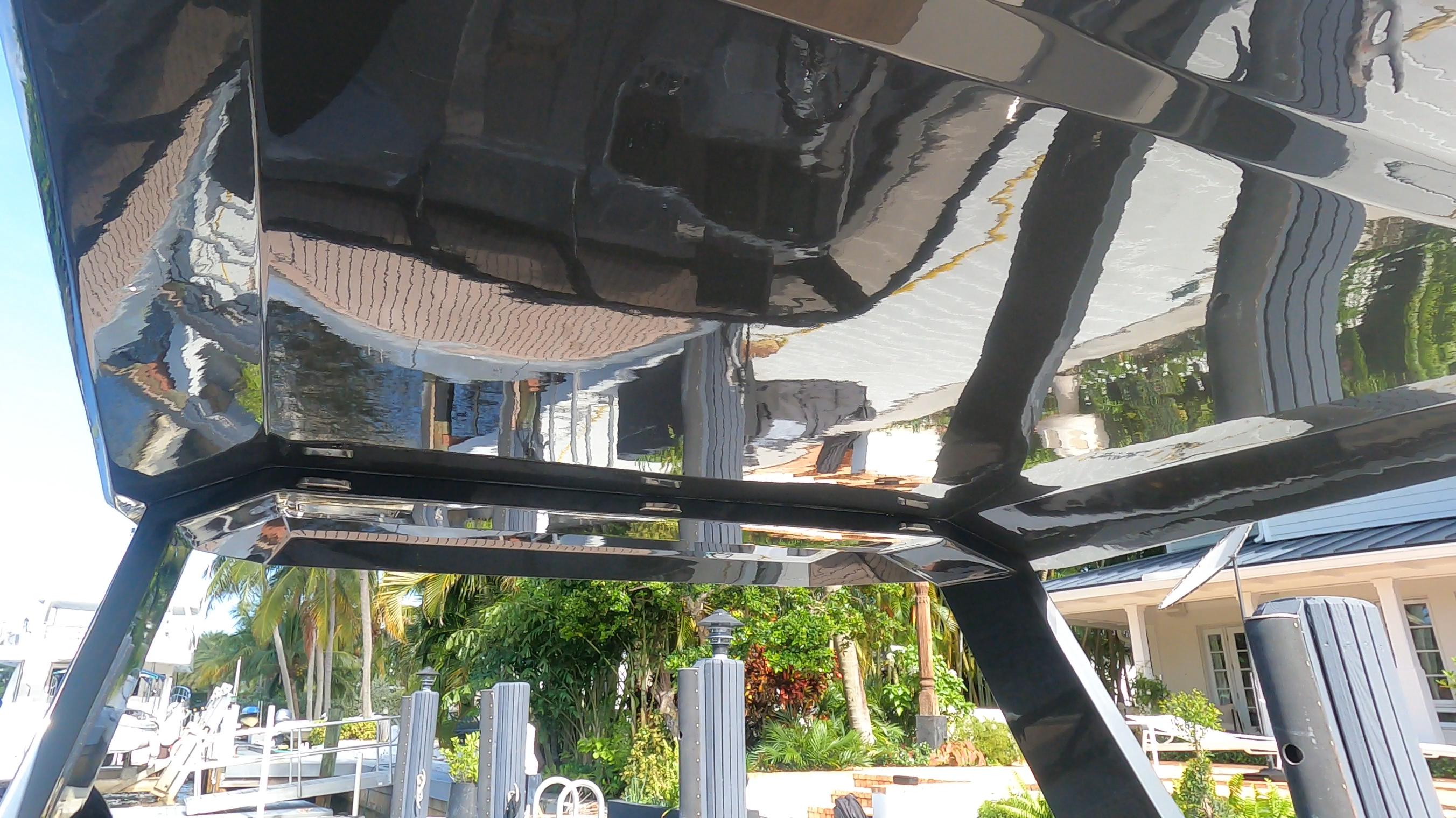 2021 Rand Leisure boat underside reflecting marina and palm trees.