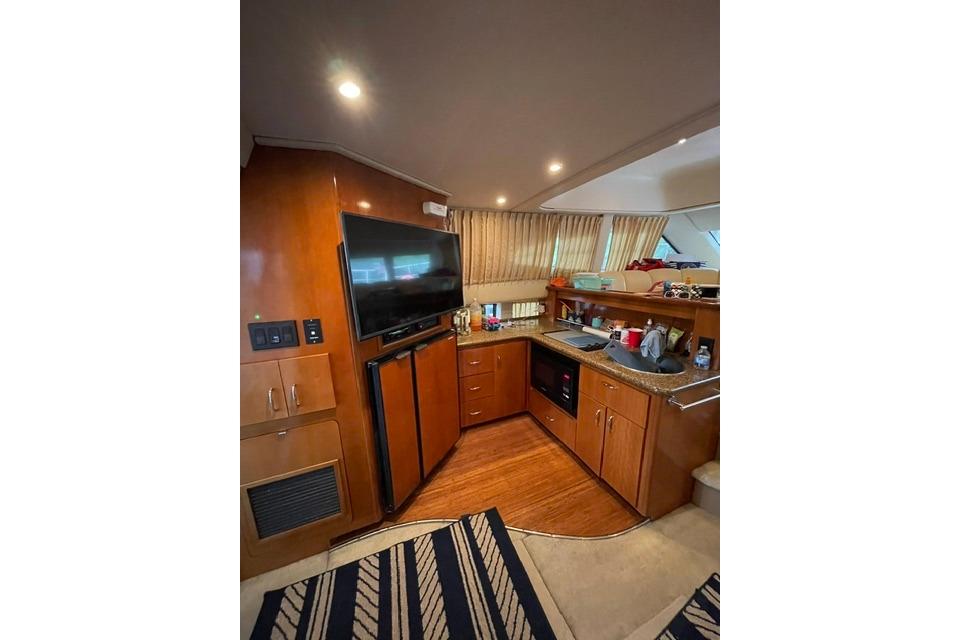 Interior of 2003 Carver 36 Super Sport yacht with modern kitchen and entertainment area.