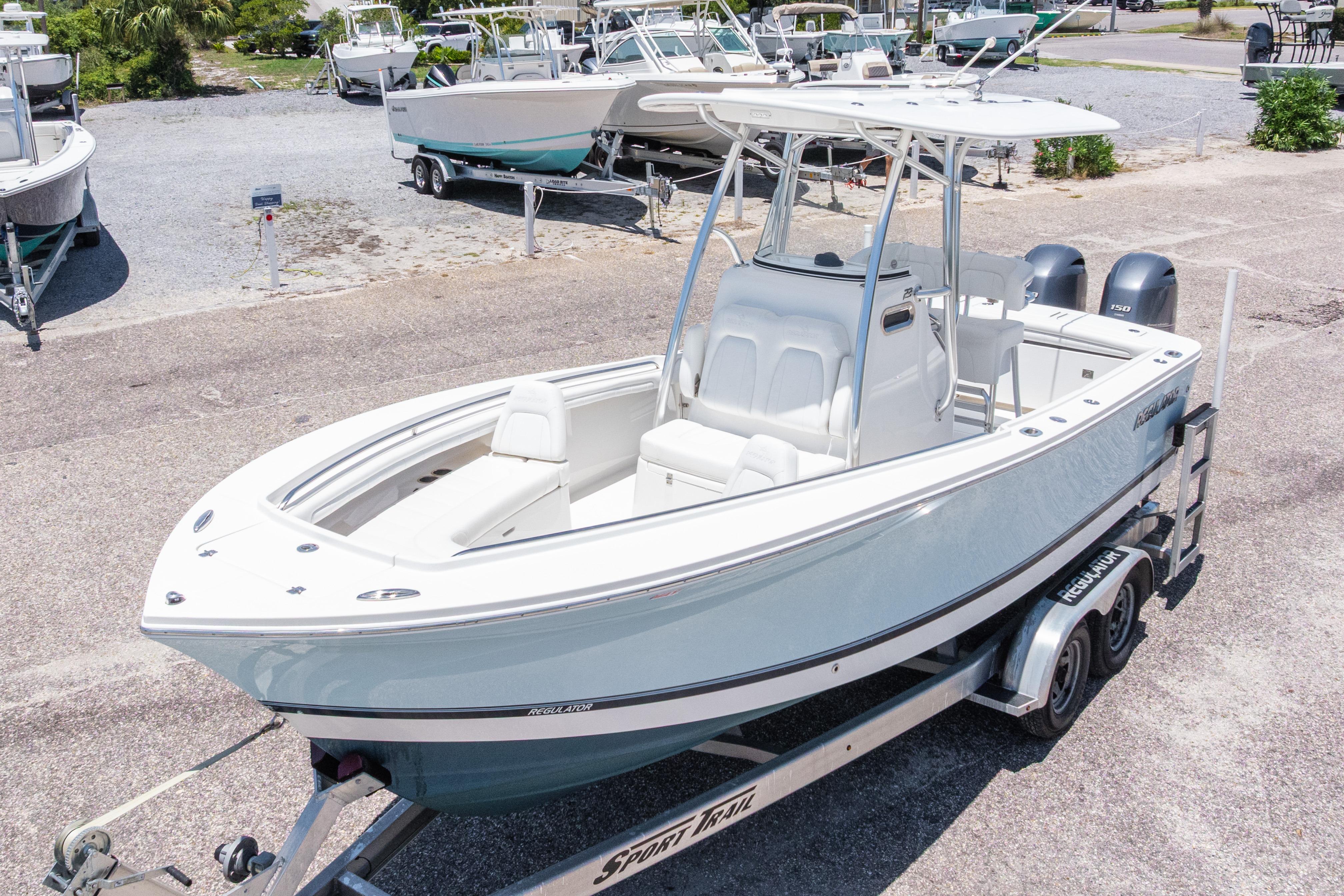 2019 Regulator 23 Center Console boat on trailer, parked in a marina.