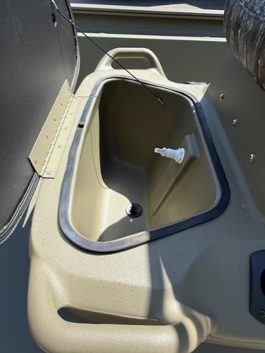 2025 Tracker Grizzly 1860 CC boat interior with storage compartment and drain plug.