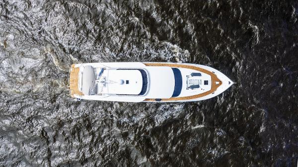Aerial view of a 2001 Grand Harbour 76 yacht cruising on dark waters.